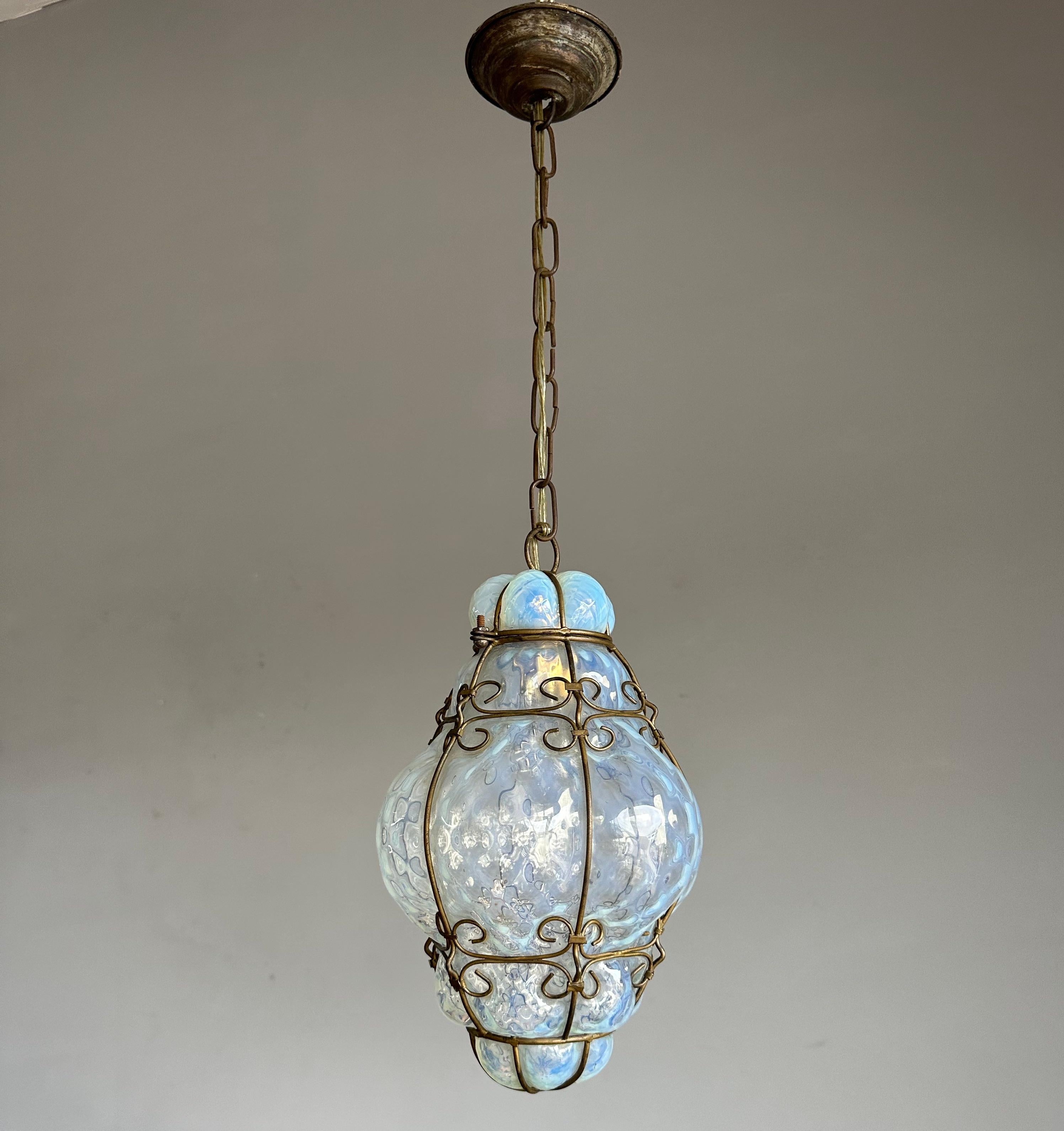 Small & brilliant Venetian pendant. Perfect blue opalescent glass in a forged wrought iron frame.

This small size antique Venetian pendant light is the only one we ever found with opalescent mouthblown glass. It makes this Murano pendant extra
