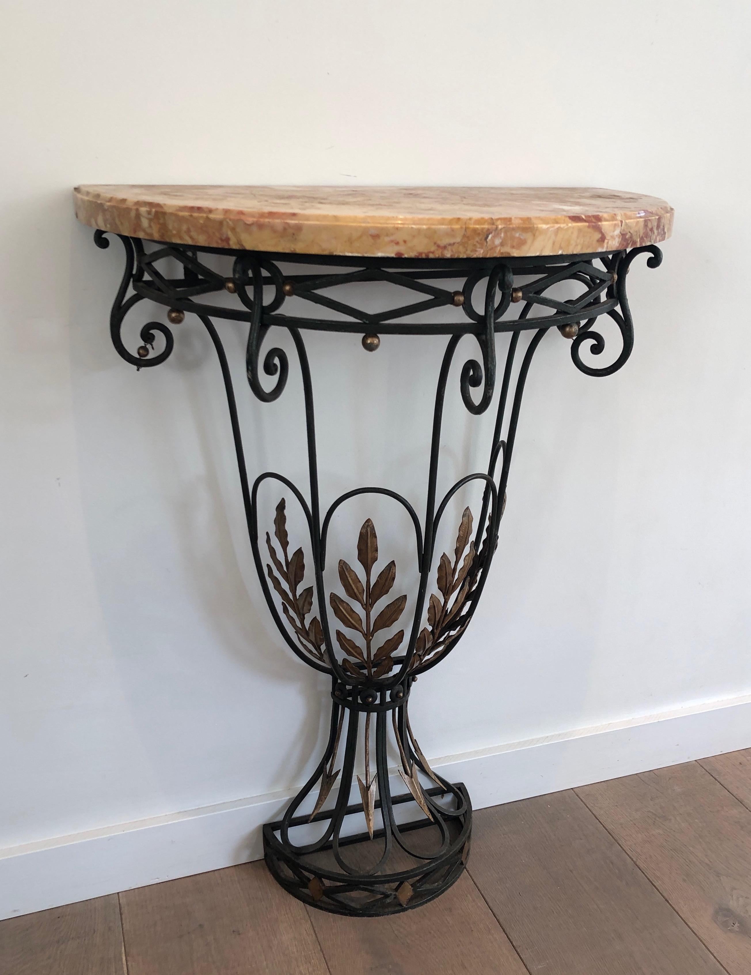 This rare small half-moon console is made of wrought iron with decorations of leaves and arrows and a marble on top. This is a French work. Circa 1940