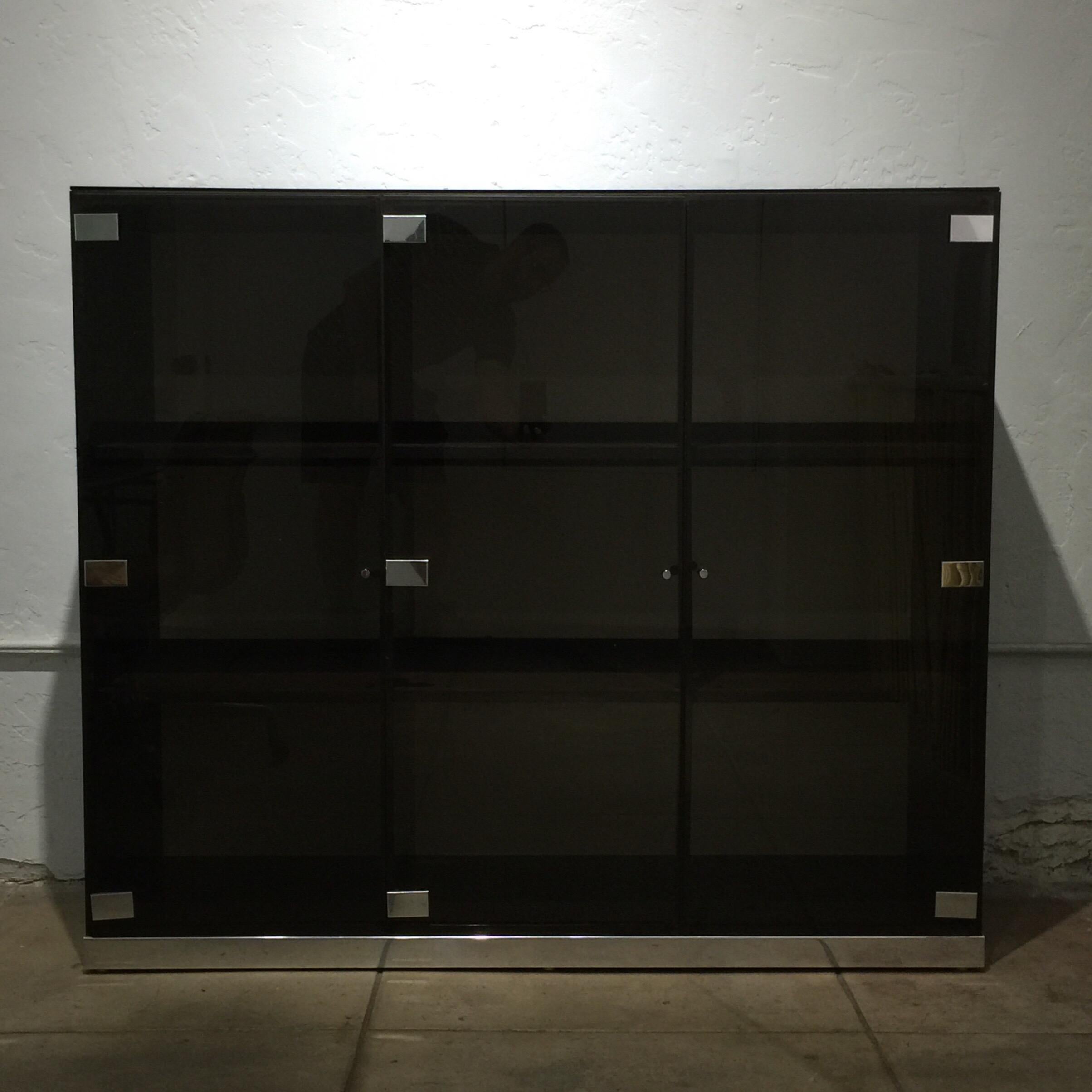 Large smoked glass and chrome cabinet or vitrine by Pierre Cardin. Three doors and six compartments. Can be backlighted (optional). A spectacular piece in any room.