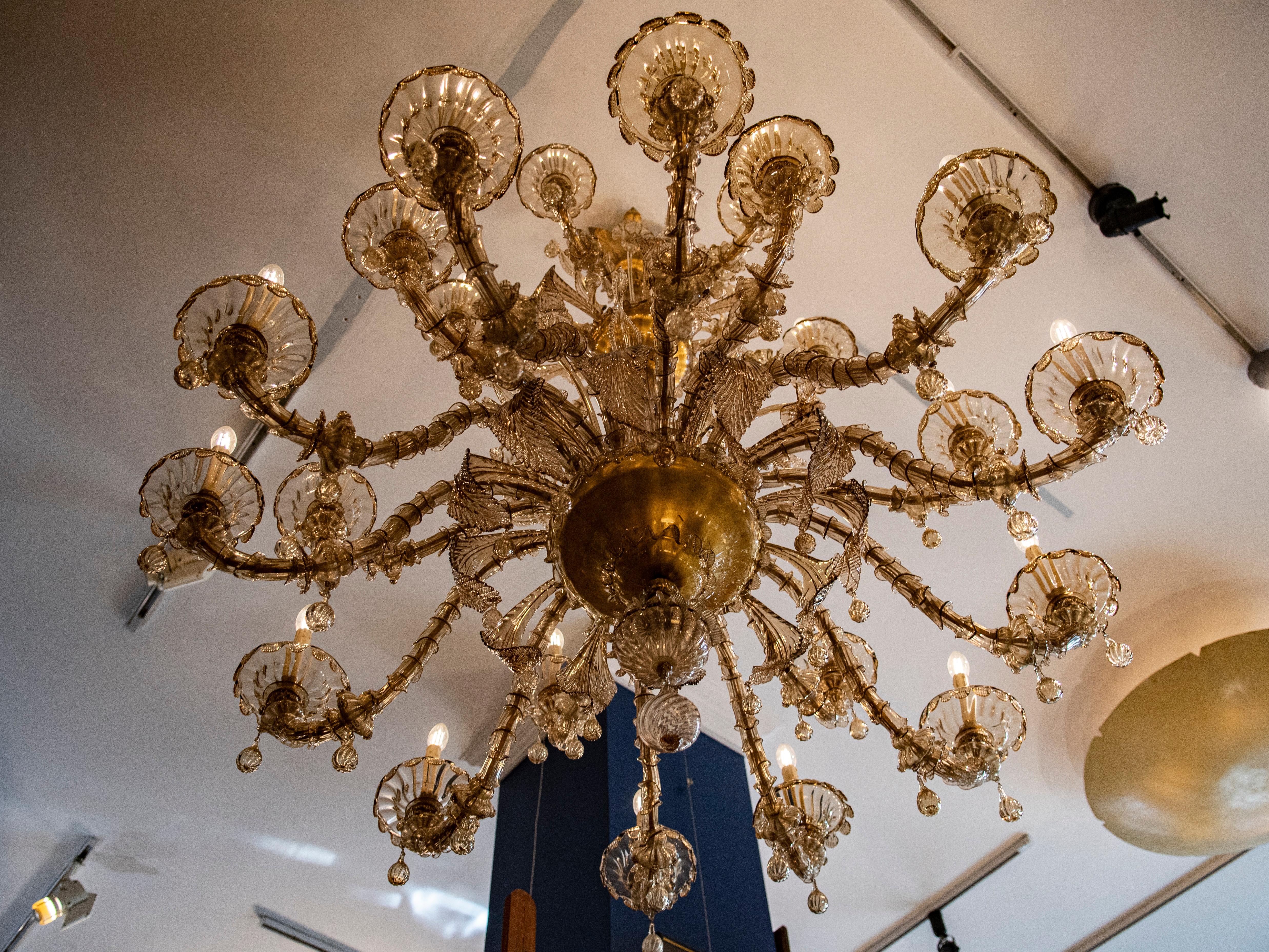 
Entrez dans un royaume d'élégance intemporelle avec ce rare lustre en verre fumé soufflé à la main de Murano, un témoignage étonnant du savoir-faire et de l'art de la verrerie italienne. Datant d'environ 1940, cette pièce exquise comporte 24 bras