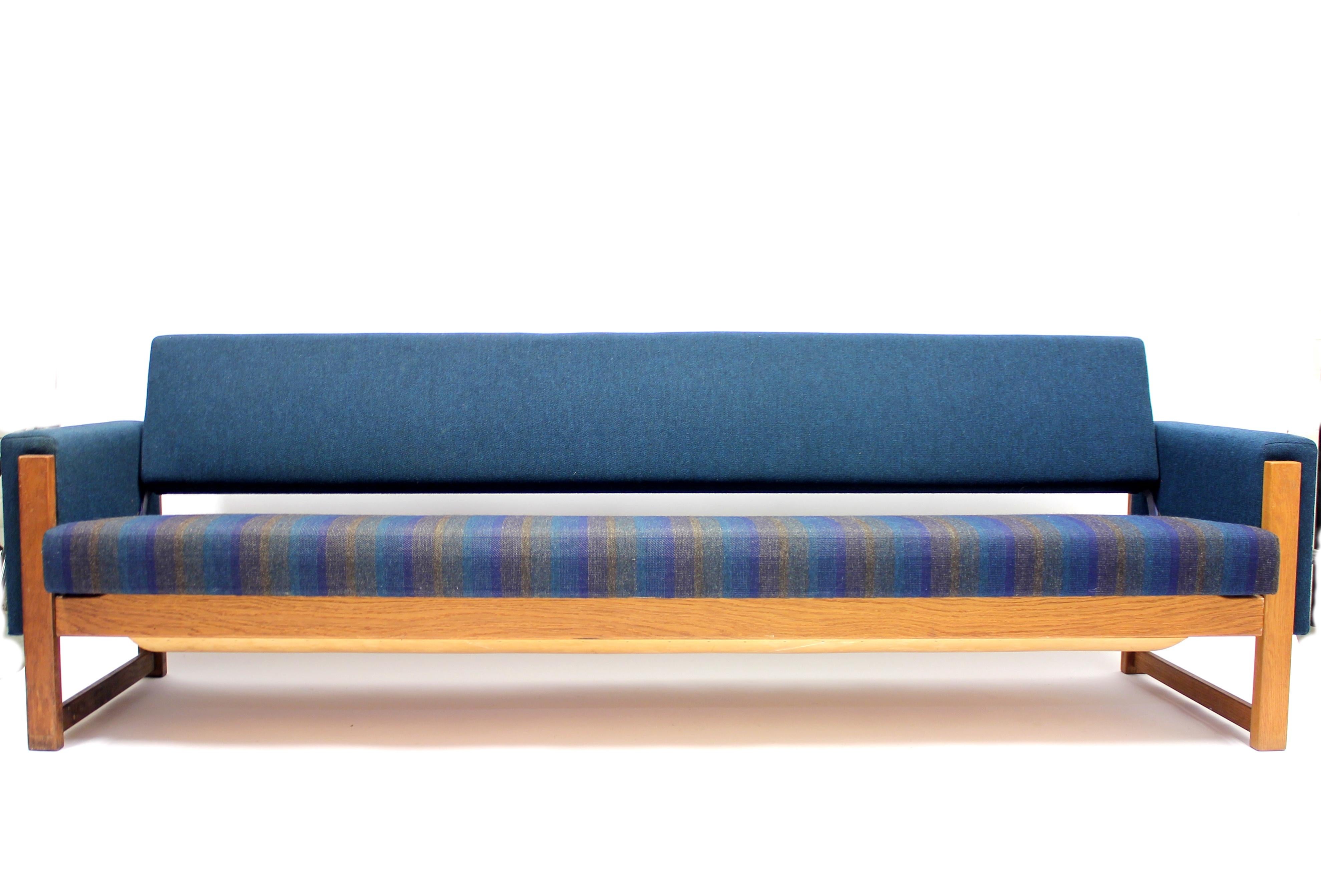 Sofa bed designed by Yngve Ekström in the 1960 for Broby Industri AB. The sofa is all original with the original blue fabric in a remarkable good condition. Some light ware on wooden parts. It´s very easy to manage. You just need one singel move to