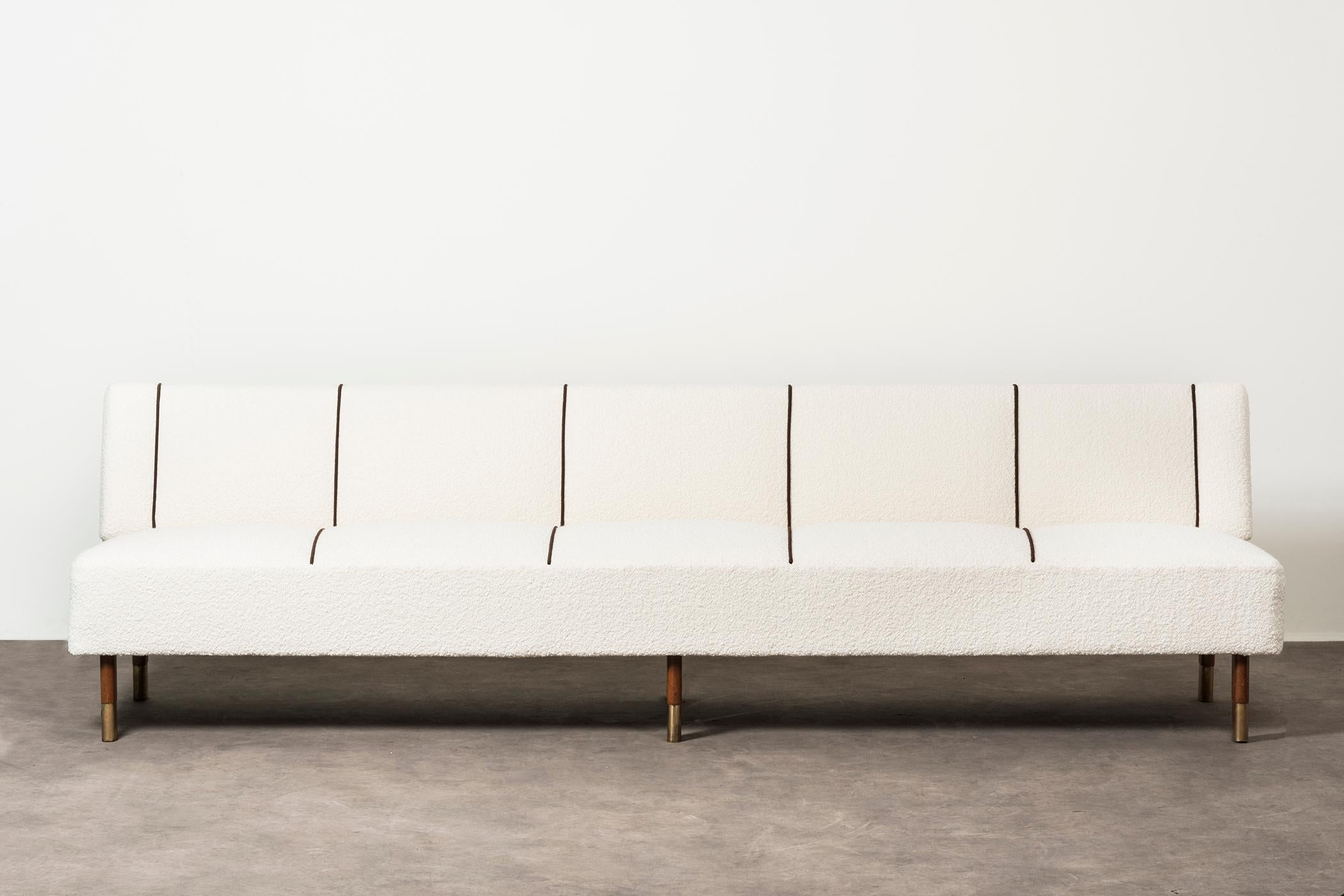 Rare sofa by Alvar Aalto. Finland, 1956. Provenance: Kansanela¨kelaitos (The Social Insurance Institution of Finland). Example provided with original label. Wood, brass, fabric upholstery. 270 x 72 x h 74 cm h seduta 43 cm. 106.2 x 28.3 x H 29.1 in