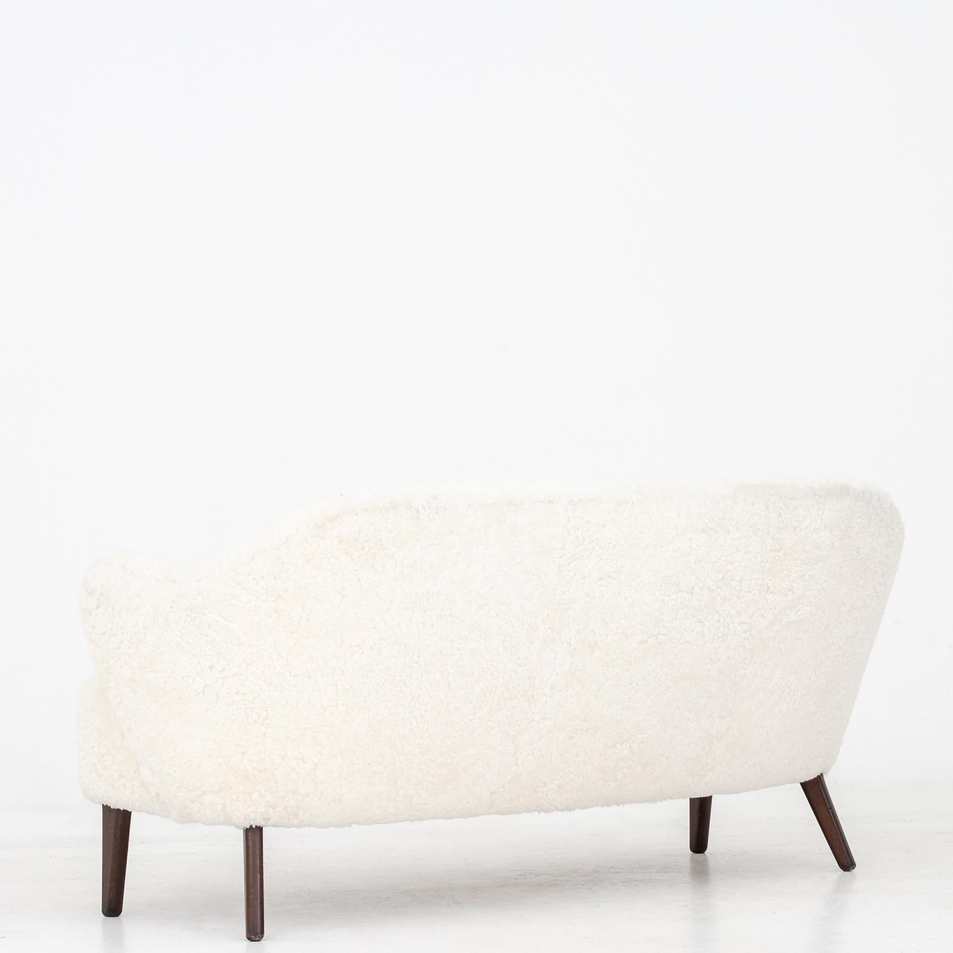 Rare sofa in lambs wool with legs of oak and beech. Designed circa 1940. Maker Jacob Kjær.