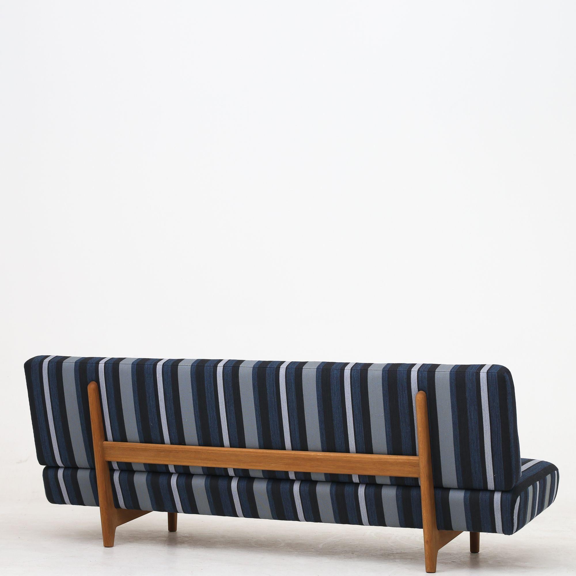 Rare sofa with patinated oak legs, newly upholstered in textile (DAW, color Stripe 7) Hans J. Wegner / Johannes Hansen.
