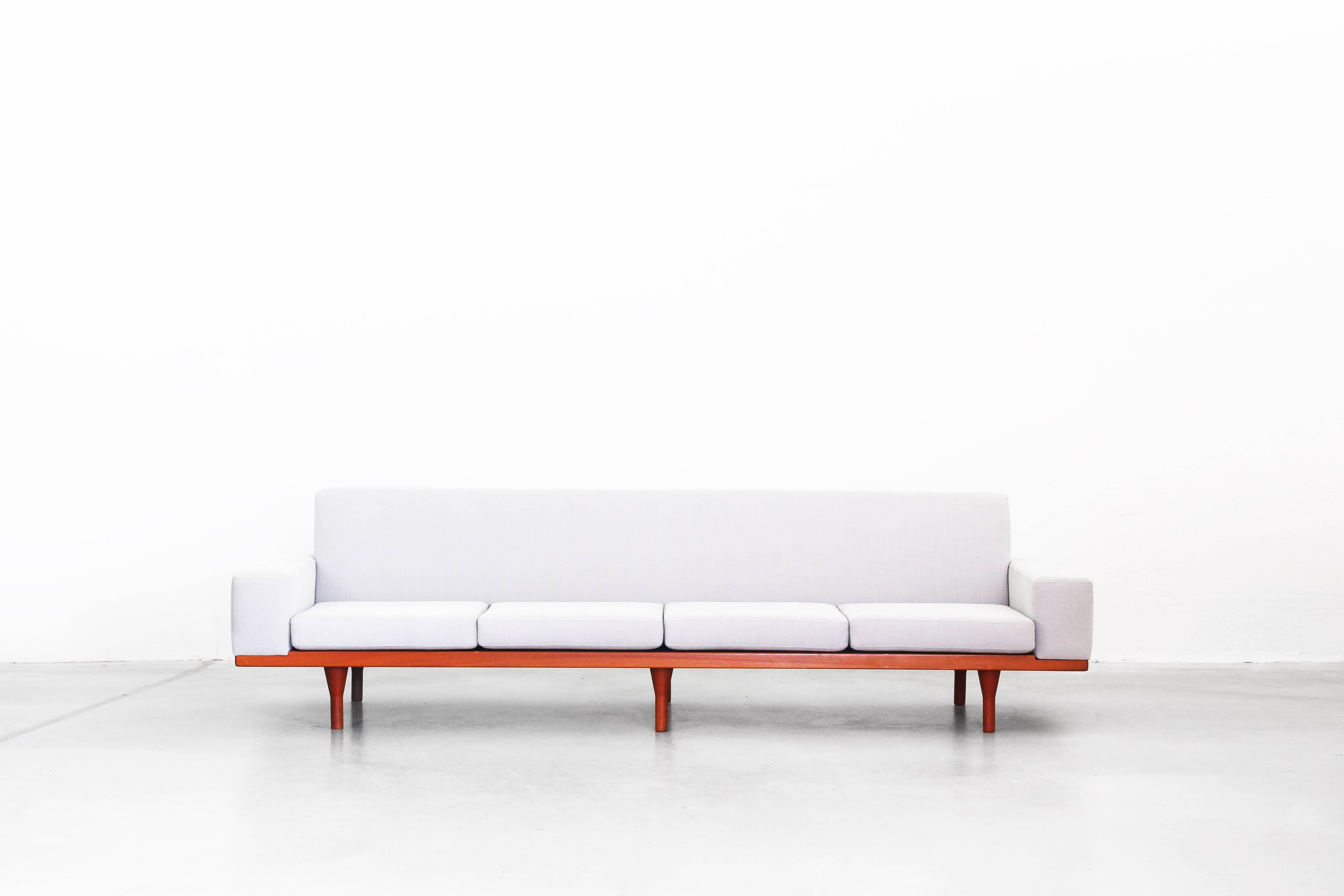 Very beautiful sofa designed by Illum Wikkelsø and produced by Søren Willadsen in the 1960s. This sofa is in an excellent condition without any damages. It is newly reupholstered with a quality fabric in light grey by Romo.