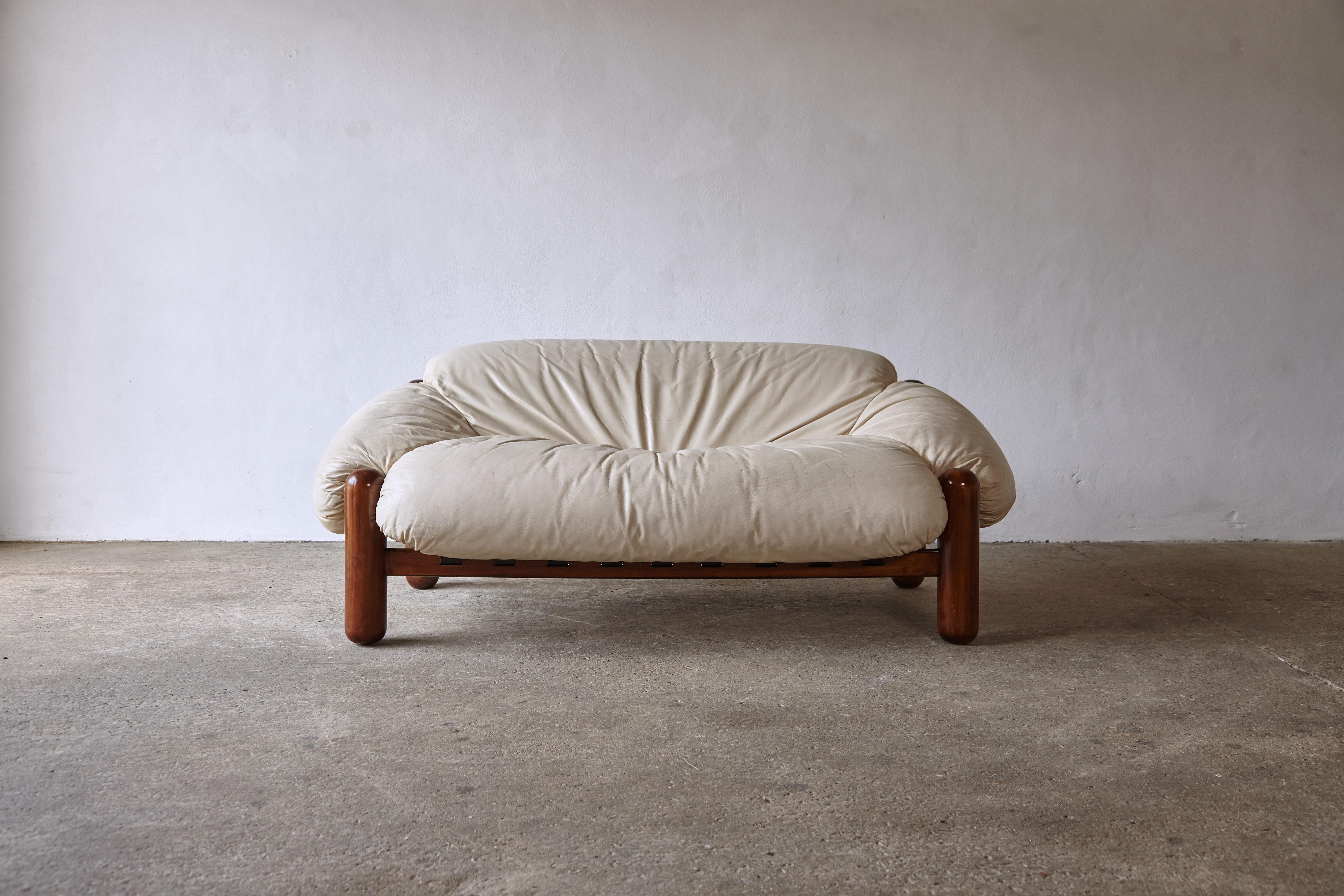 A superb and rarely seen sofa. As comfortable as it looks. Made in Italy the chairs nod to Brazilian mid century design. The wooden frame is in original condition, structurally sound, with some signs of use and age. The original cream leather fabric
