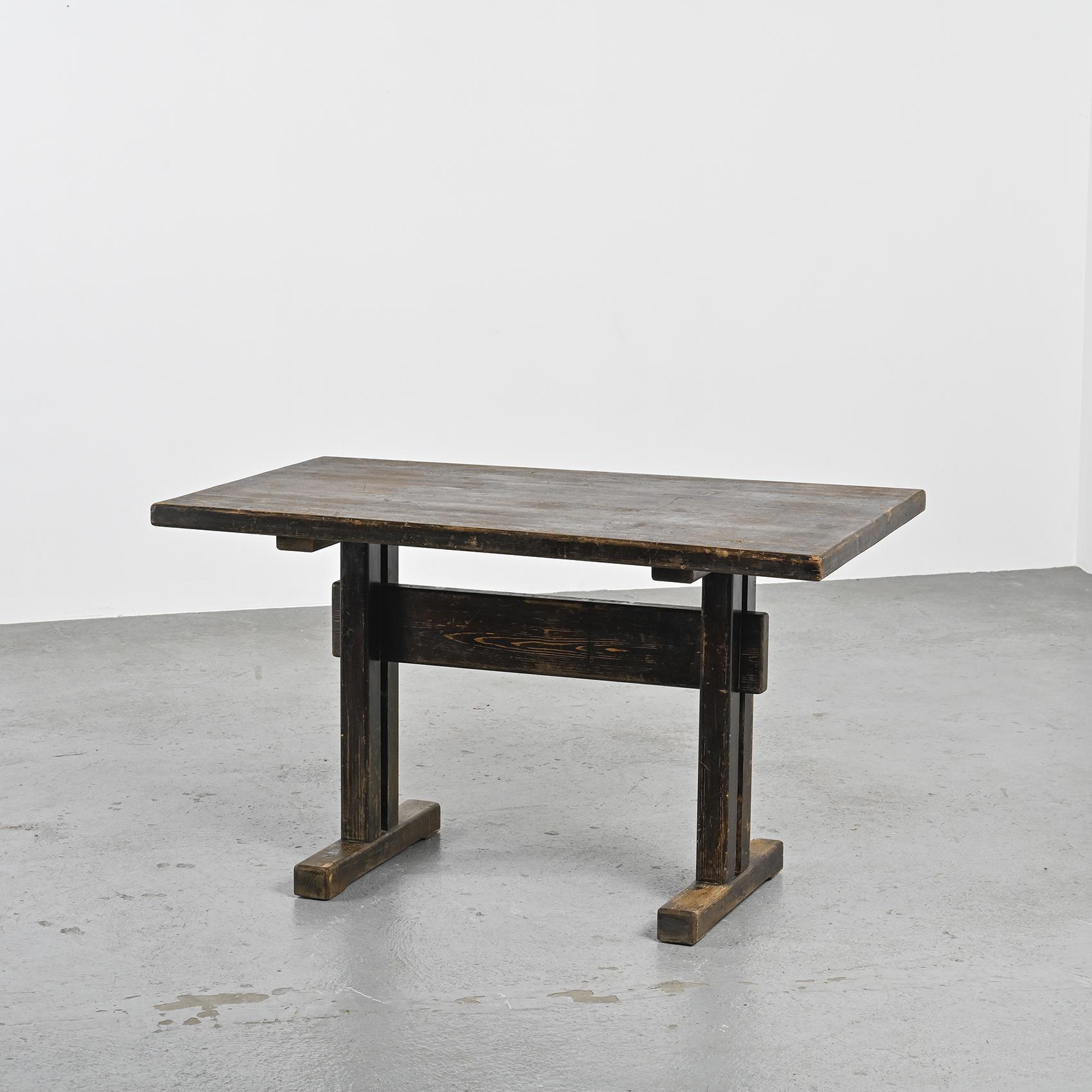 
Rectangular tabletop and braced base table, rare version with wedge mounting, selected for the Les Arcs ski resort, entirely made of dark stained solid pine.

Passionate about mountains, Charlotte Perriand worked during 20 years (1967-1989) on the