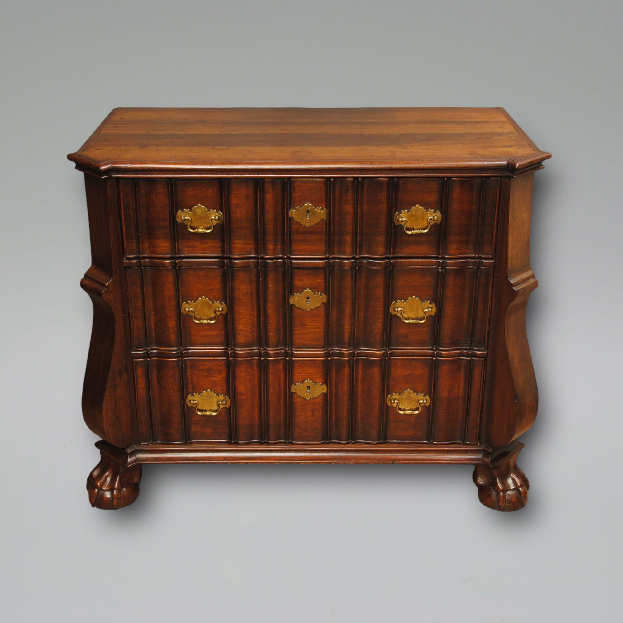 An 18th century Cape block front chest.
This Dutch colonial chest was made in the Cape using local stinkwood it has the original brass handles and carved paw feet.