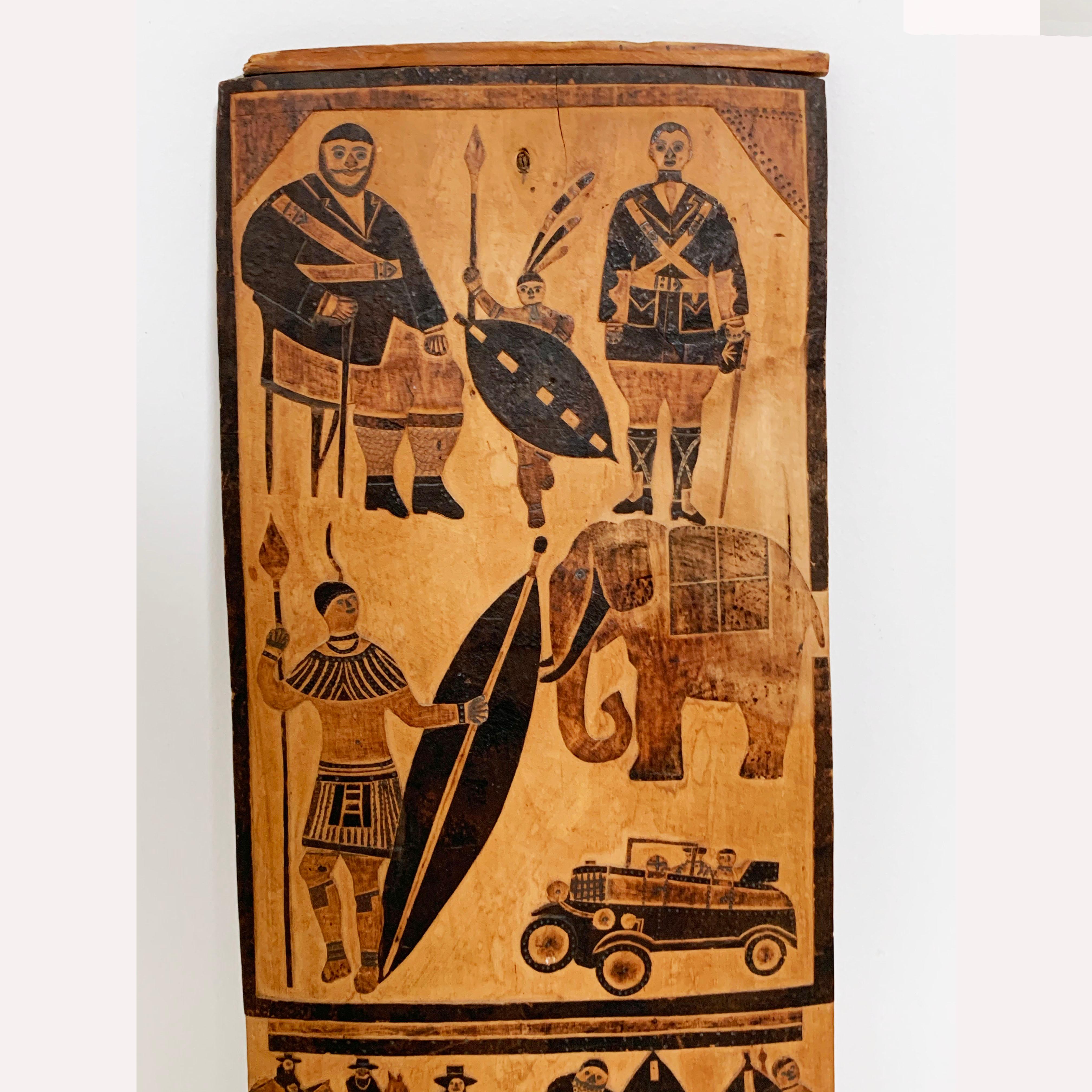 A rare relief carved and pigmented wooden storyboard panel detailing events of the late 19th and early 20th century related to South Africa’s Zulu history and the Boer Wars. Atop this folk art panel, dated 1937, is a depiction of two heroes of the