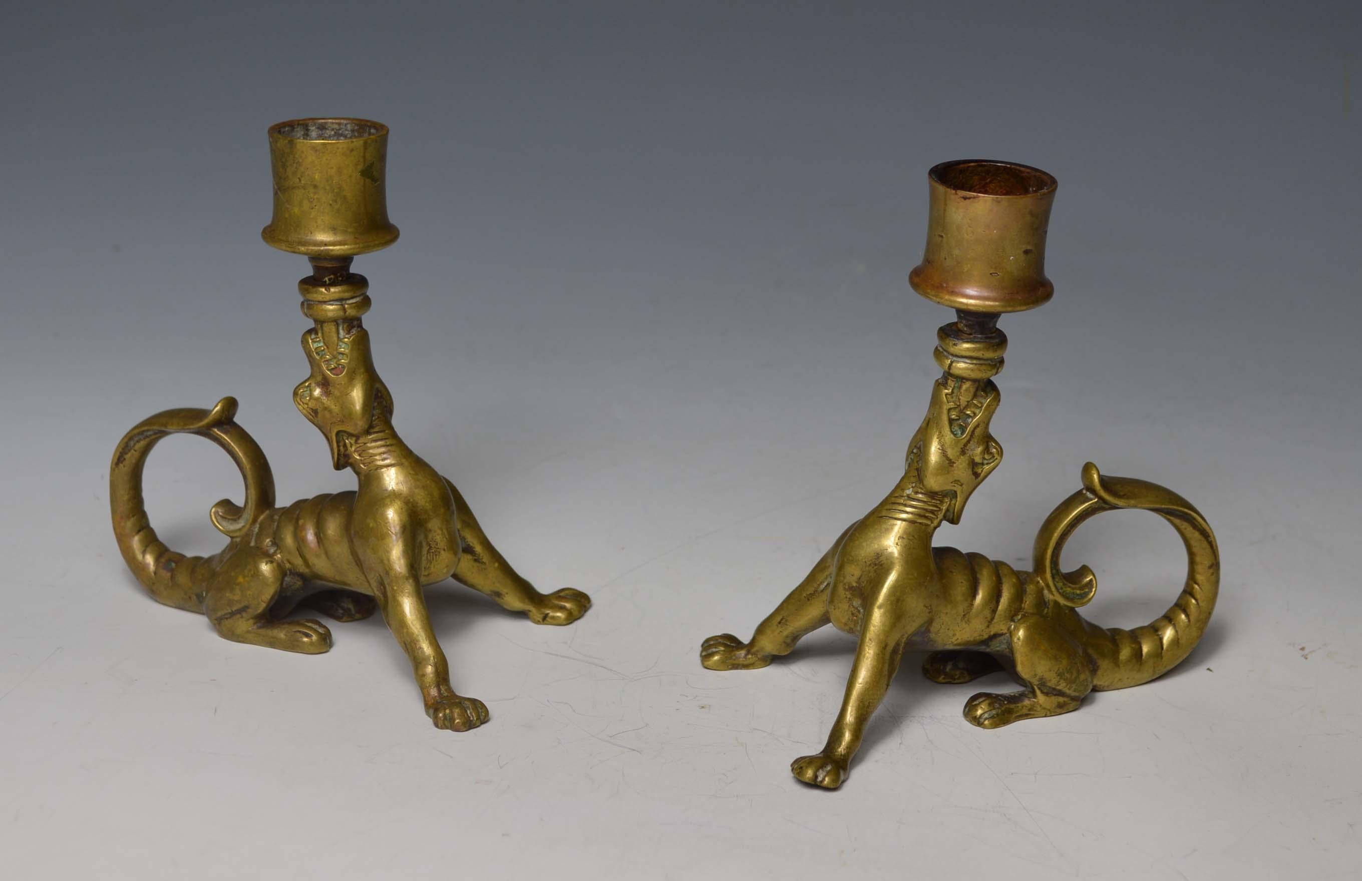 A rare pair of South German brass candleholders superbly modeled as
Gothic style mythological hounds with long curling tails tails and heads pointing upwards surmounted by candleholders
South German, 18th century or earlier
Measures: Height 14