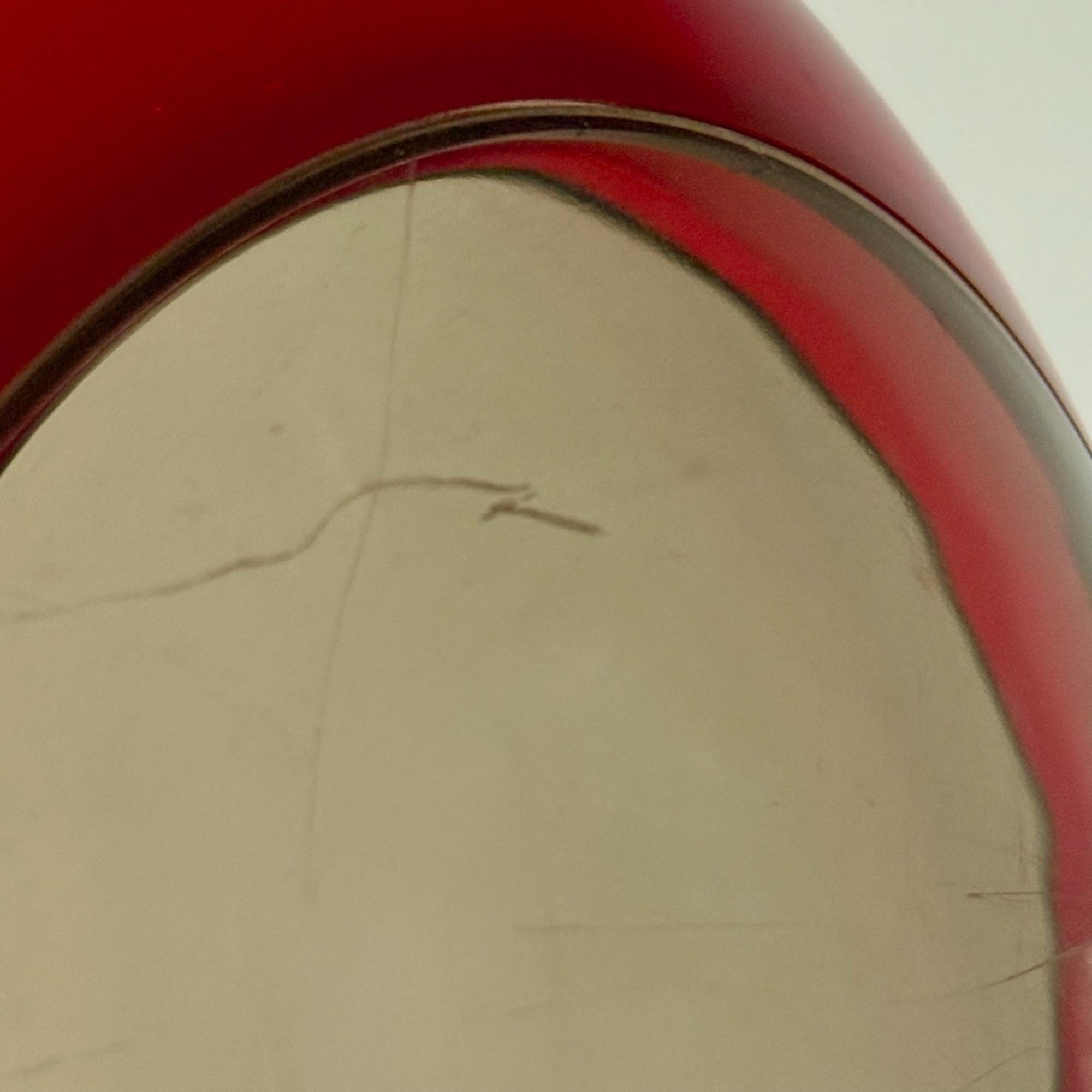 This rare and highly collectible “Bug Eye” pendant lamp was produced by Belgian brand Massive in the 1970s and is a striking example of Space Age European lighting design. Its large red plexiglass globe is punctuated by four smoked convex portholes,