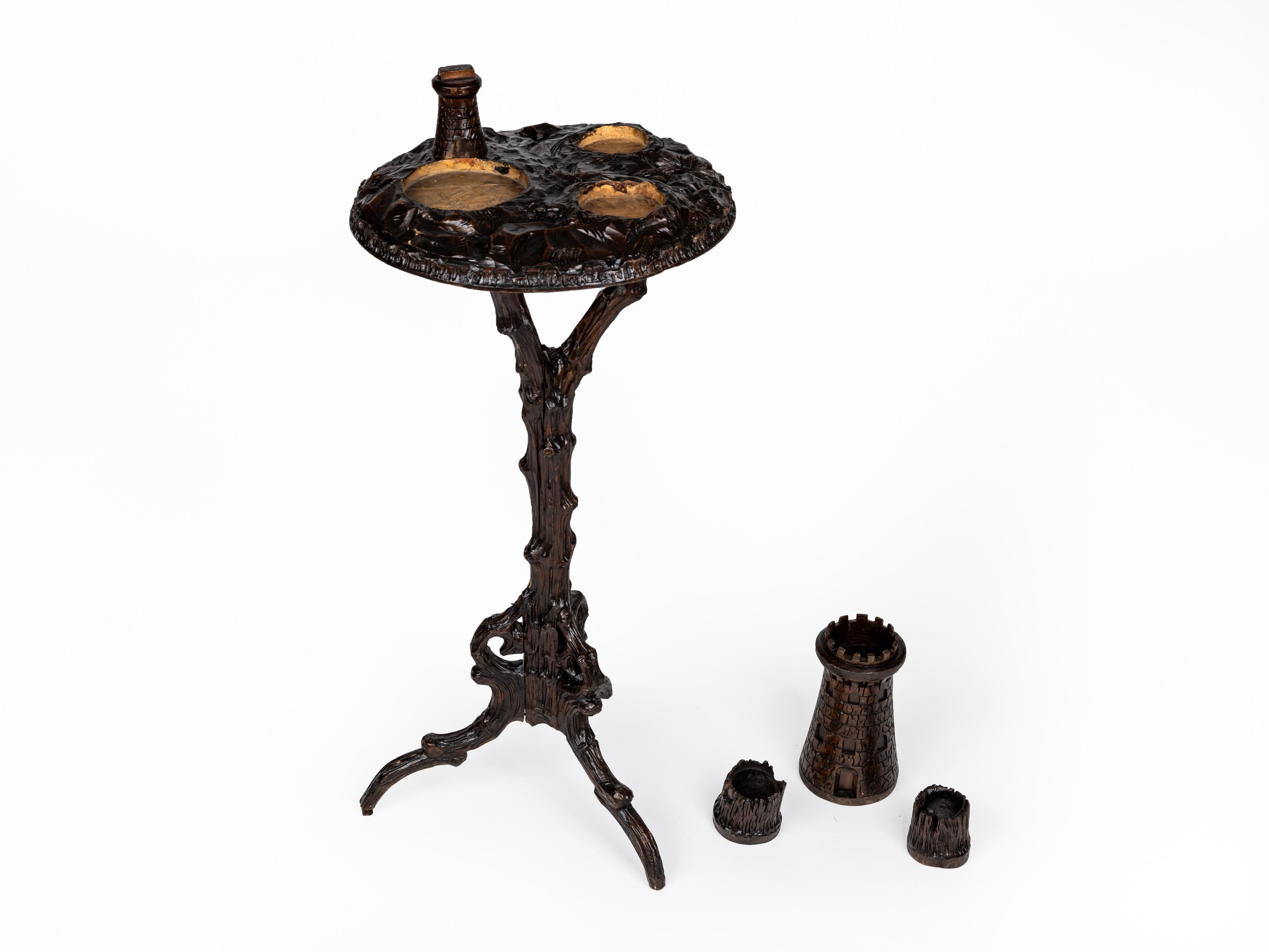 Fascinating smoking table with detachable accessories, made in Bavaria or Austria at the end of the 19th century.

The ingenious design features a column - stylized as a branch growing out of curving roots - which form the triangular base.
The top