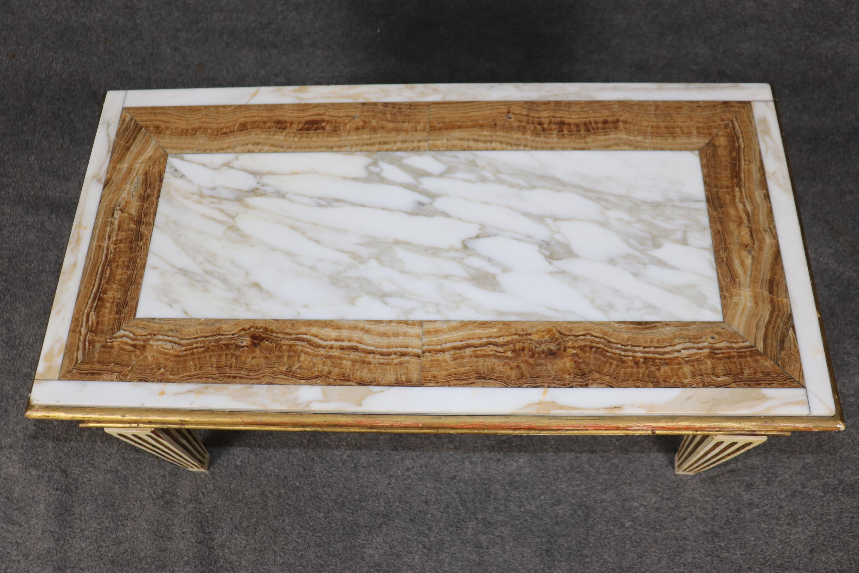 This is a superb coffee table with a specimen marble inlaid top and fantastic gilded and creme painted frame. The table has some time-worn distressing and will show minor signs of use and age but nothing significant for its age. The table is a gem,