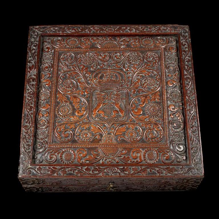 A rare Sri-Lankan Portuguese rosewood games box, late 16th-early 17th century; the whole box is profusely carved with various motifs, including two combative lions facing each on the top of the box, and a double headed eagle on the bottom. The