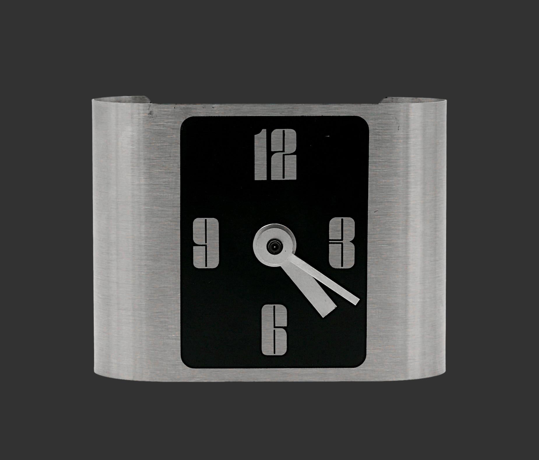 Striking mid-century table clock, France, circa 1970. This elegant brushed stainless steel table clock embodies the chic Parisian avant-garde design. The clock’s sleek, minimalist design features the distinctive use of stainless steel, a material