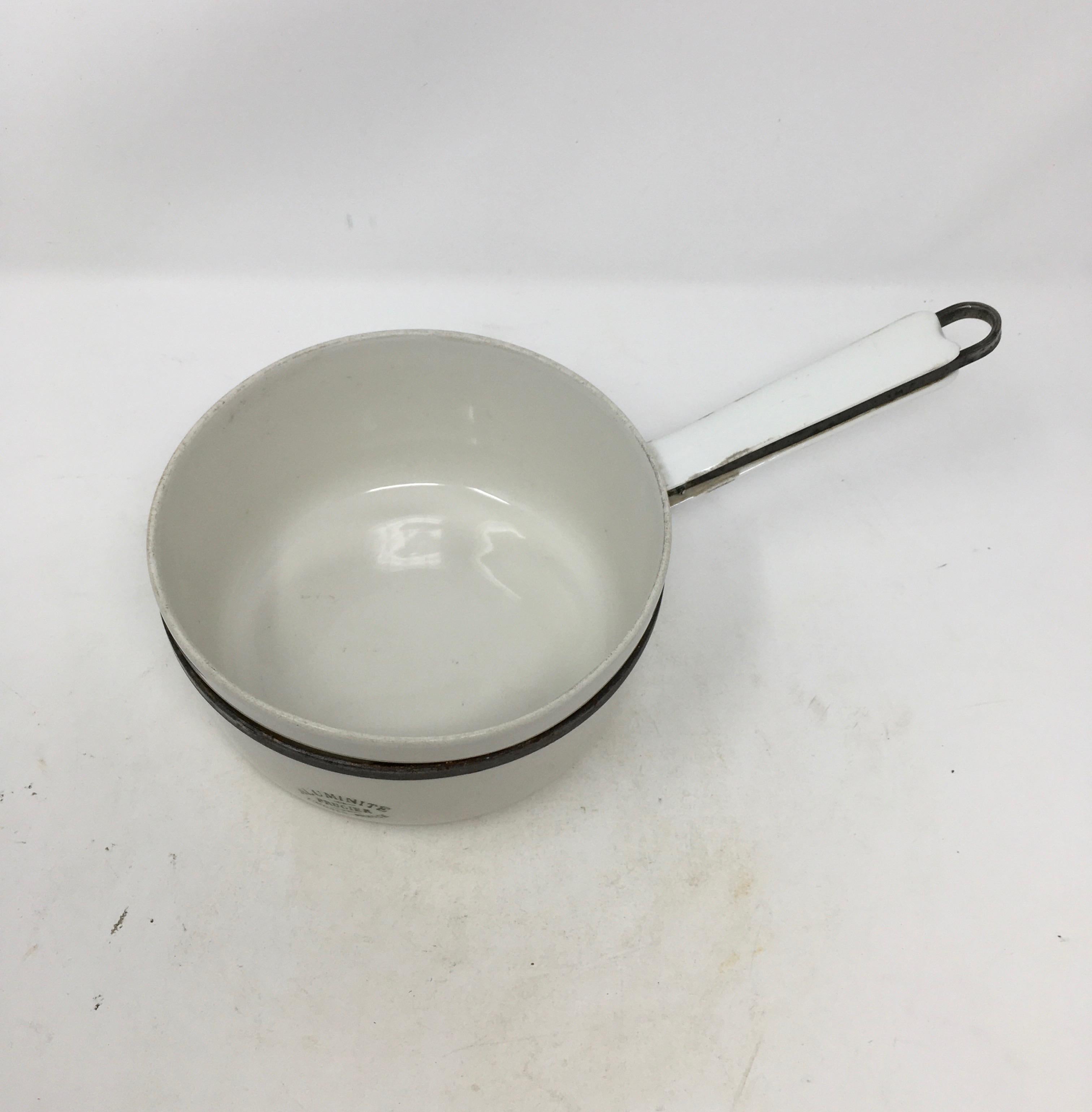 Rare stamped aluminite Frugier Limoges France pot. Made of porcelain and steel. 
This pan is made of porcelain or aluminite, and can be placed on the fire. It also has a porcelain handle which is rare.

This piece weighs .5 lb.
