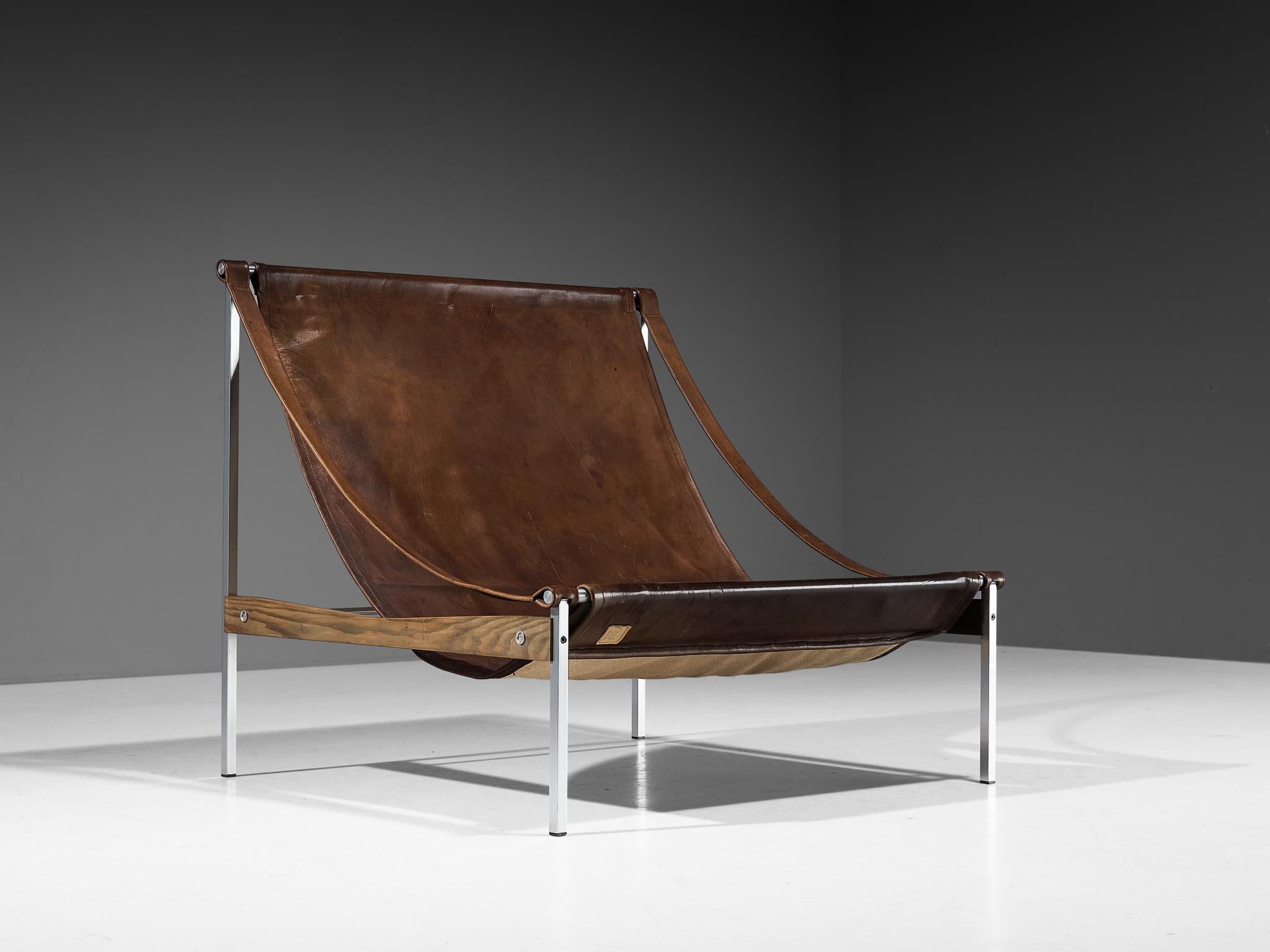 Stig Poulsson, lounge chair model 'Bequem', cognac leather, steel, ash, Denmark, designed 1968-1969

This 'Bequem' lounge chair is designed by Stig Poulsson. The most striking feature of this extraordinary chair is its sheer size. The width of this