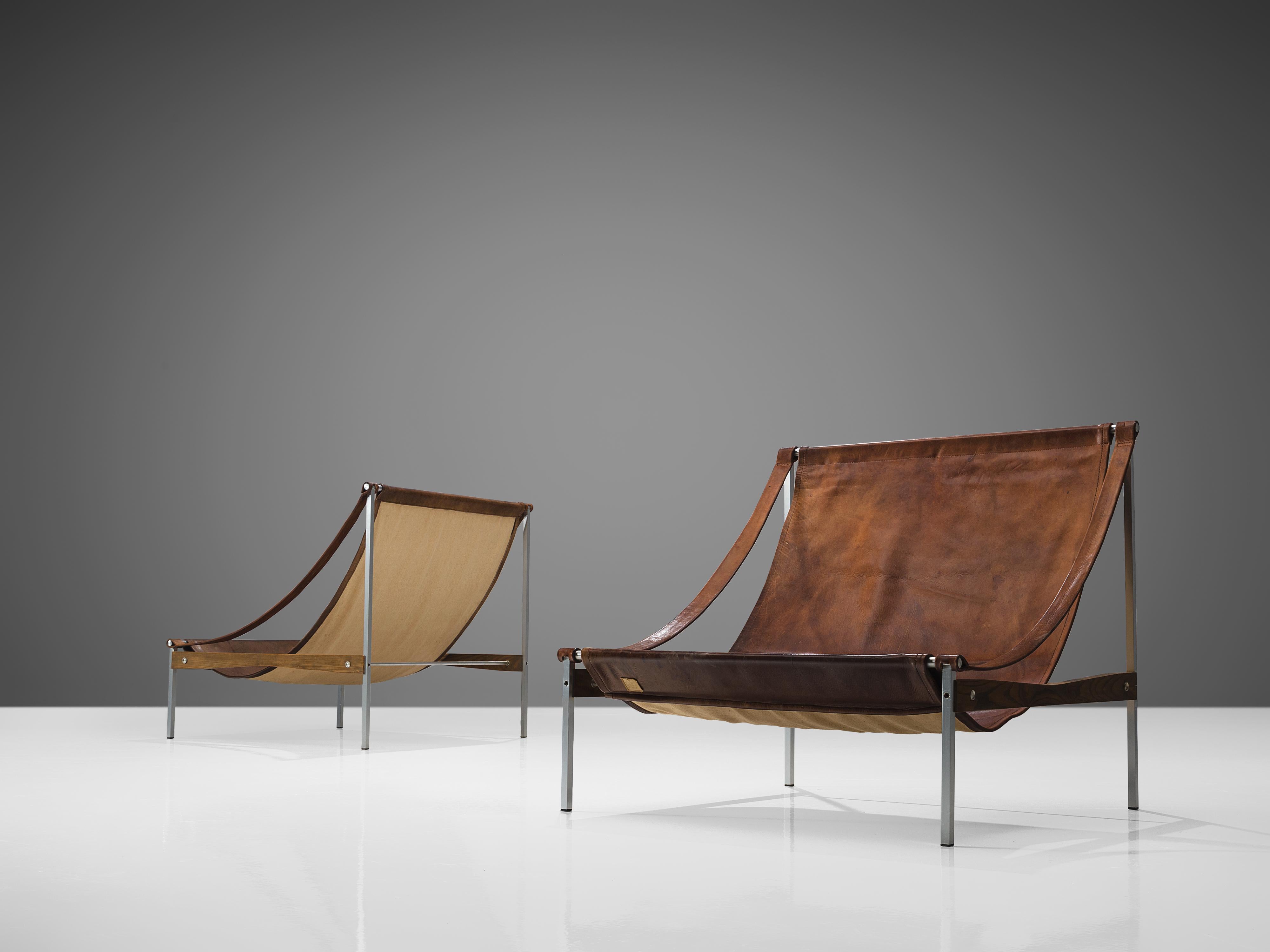 Danish Rare Pair of Stig Poulsson 'Bequem' Lounge Chairs in Cognac Leather