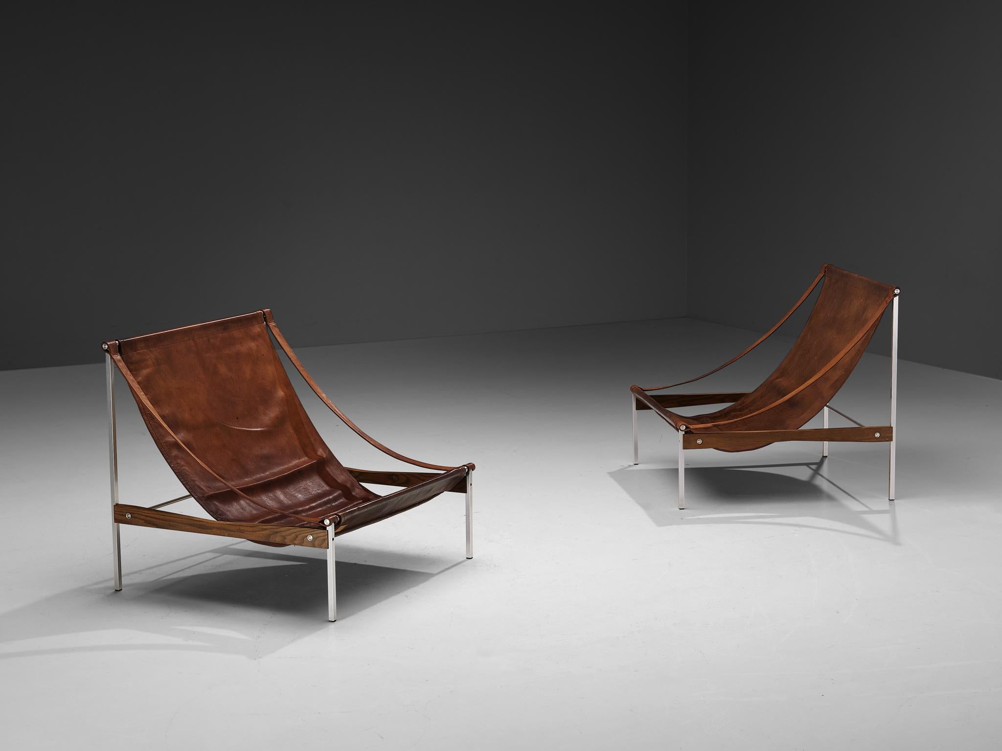 Stig Poulsson, pair of lounge chairs, model 'Bequem', leather, aluminum, ash, Denmark, designed 1968-1969

This 'Bequem' lounge chair is designed by Stig Poulsson. The most striking feature of this extraordinary chair is its sheer size. The width of