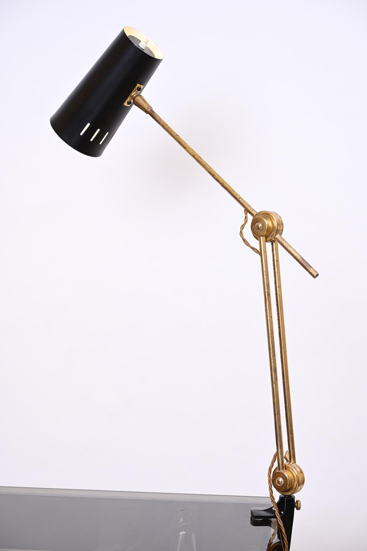 Rare Stilnovo articulated desk lamp with black shade.

Brass has nice patina and the lamp has been rewired.