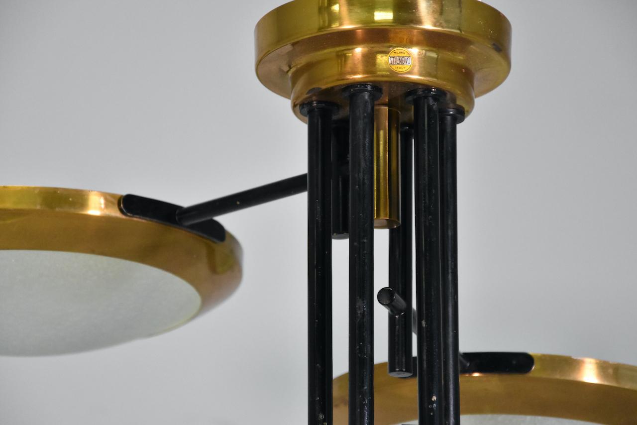 Splendid Stilnovo three discs ceiling lamp in brass and glass, Italy 1950s Reference : Botteghe Storiche di Milanesi, Milan, 2006, p. 21 for the five-armed variation from the Cartoleria Adua, Milan.
available pair.