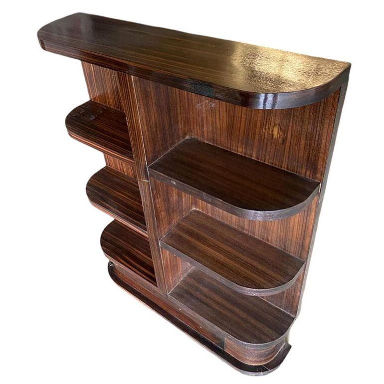 Rare Custom-Made Streamline Art Deco Tiger Ebony Book Shelf showcases luxurious craftsmanship with its sleek, streamlined design. Made with an exotic Madagascar Tiger Ebony veneer, it embodies the elegance of the Art Deco era, adding a sophisticated