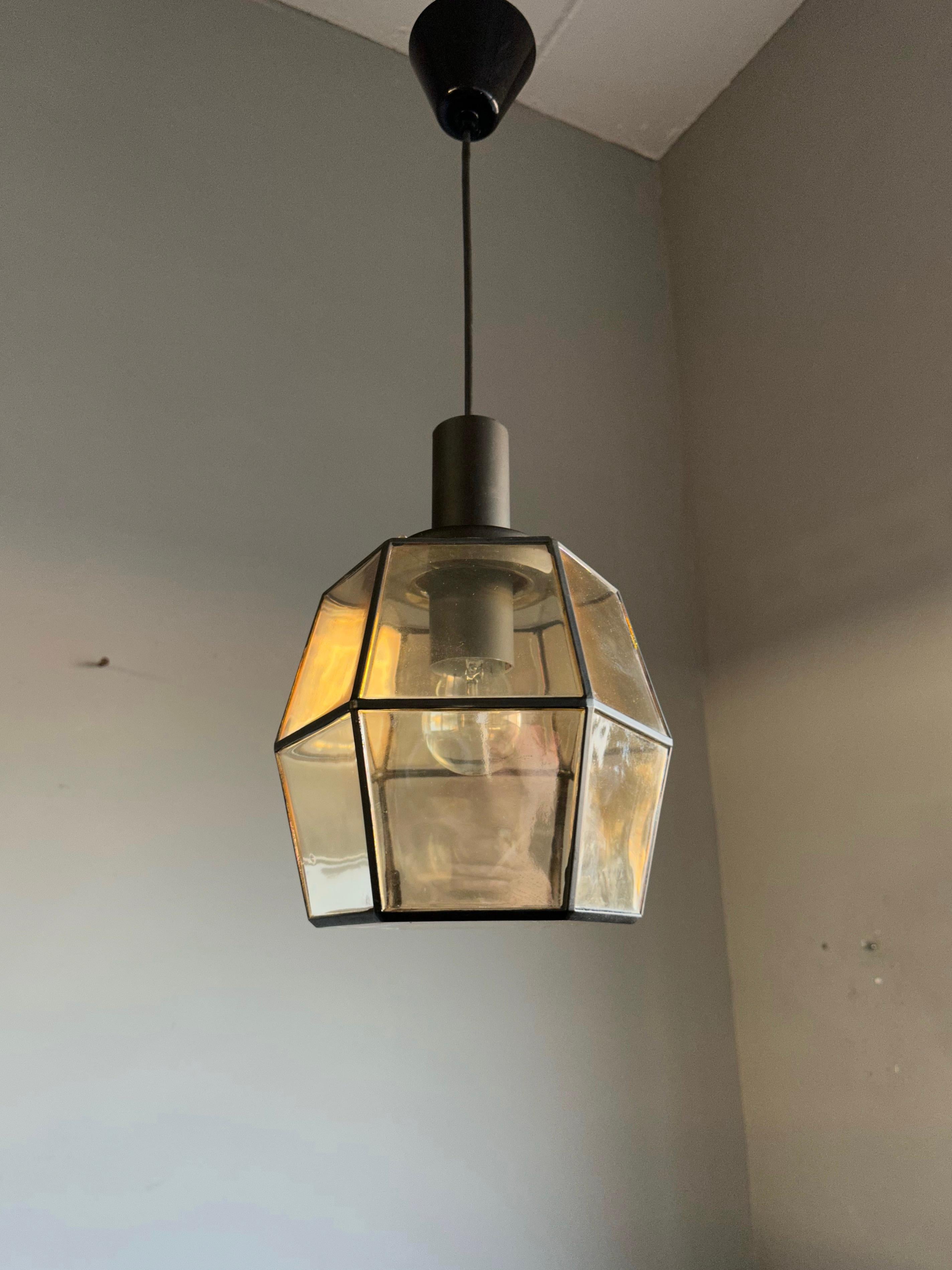 Timeless and good size mid-century pendant.

This rare ceiling lamp from the mid-century era could be the perfect lighting solution for an entrance or any other small living space. This handcrafred angular-globe design is a rare sight and an