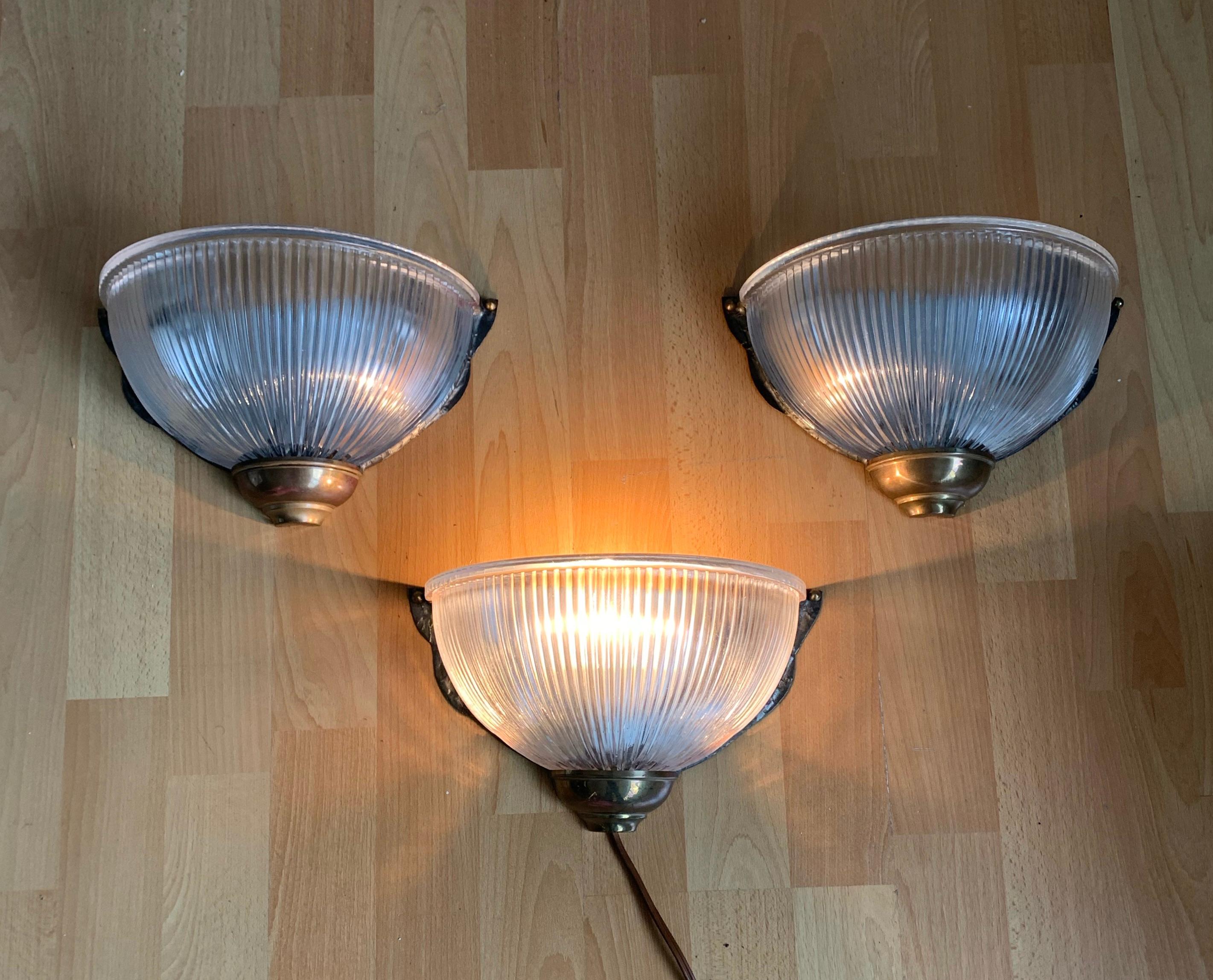 Wonderful looking and easy to mount set of three prismatic glass wall sconces.

Finding the right wall lights for a Mid-Century Modern or for an Industrial style interior can be a Challenge. That is exactly why we did not think twice when we first
