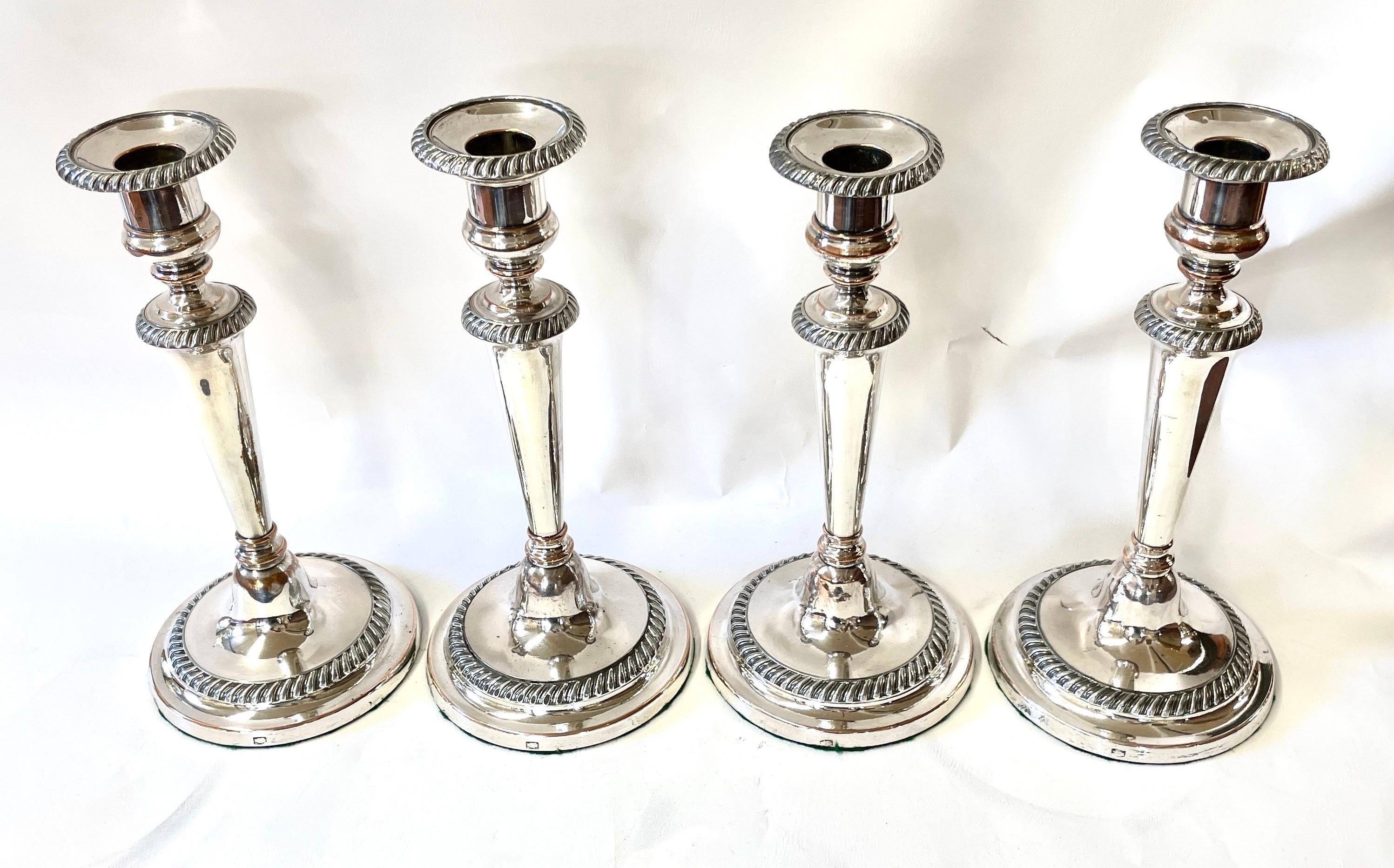 Very Rare Suite of four matching Antique English Geo. III Sheffield Plate round base gadroon border Candlesticks. The gadroon border is reminiscent of those made by one of Sheffield's most illustrious and collected silversmiths, Matthew Boulton.