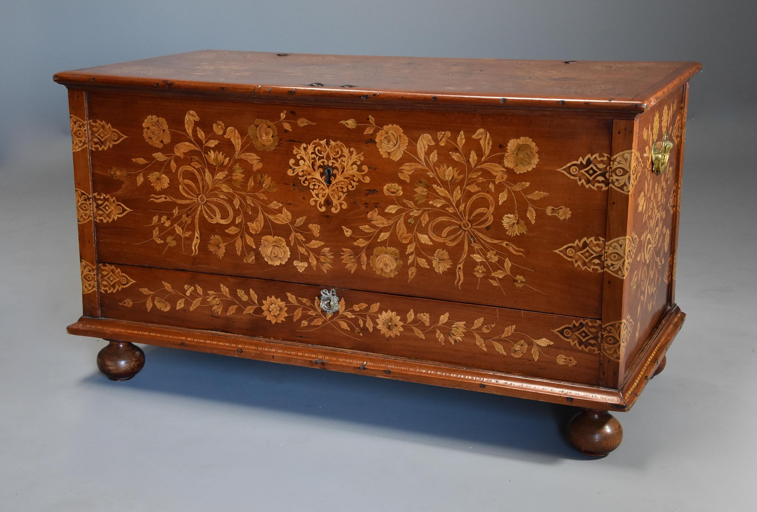 A rare superb quality mid 19th century highly decorative Continental floral marquetry teak chest, possibly Dutch.

This chest consists of a solid teak top with fine floral marquetry design with inlaid ribbon and other decoration with original