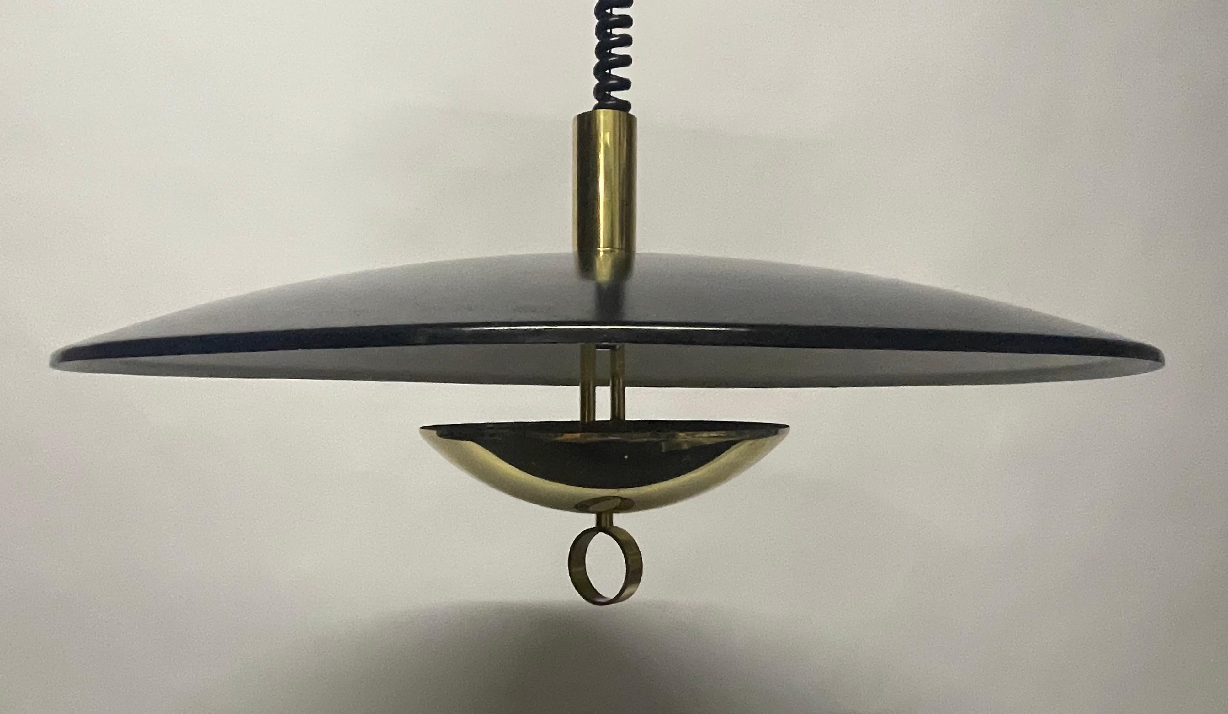 Rare pendant lamp by Hillebrand, Germany circa 1950s.
Cup-shaped reflector in white and black lacquered aluminium. Counter cup in polished brass.
Adjustable in the height. min. 25.59 inches - max. 64.96 inches.
In an excellent vintage