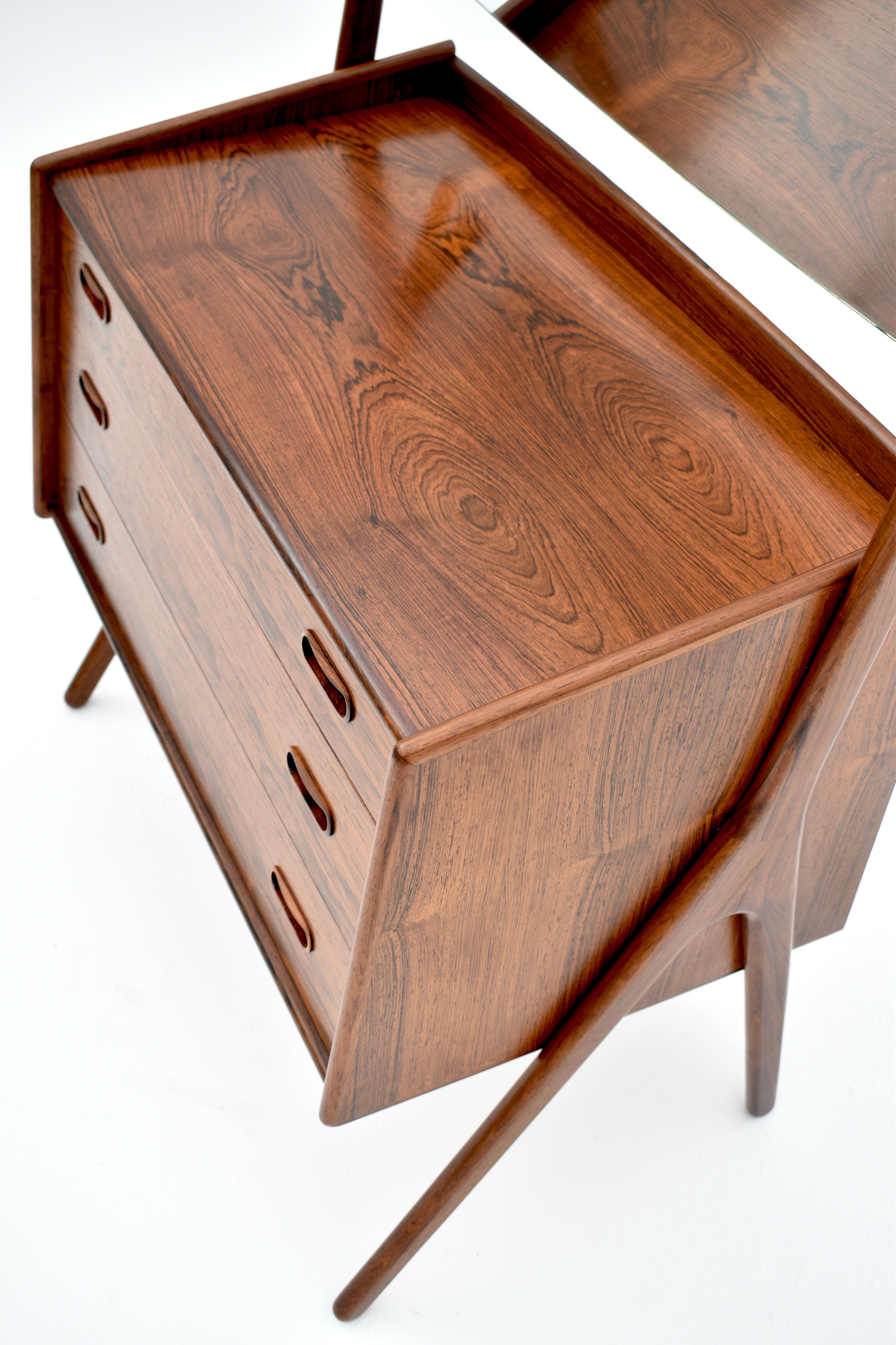 An extremely rare (we have never seen another example offered for sale anywhere) Brazilian rosewood cabinet designed by Svend Aage Madsen for NB Mobler.

The angular carcass held by highly sculptural scissor legs crafted from solid rosewood. A