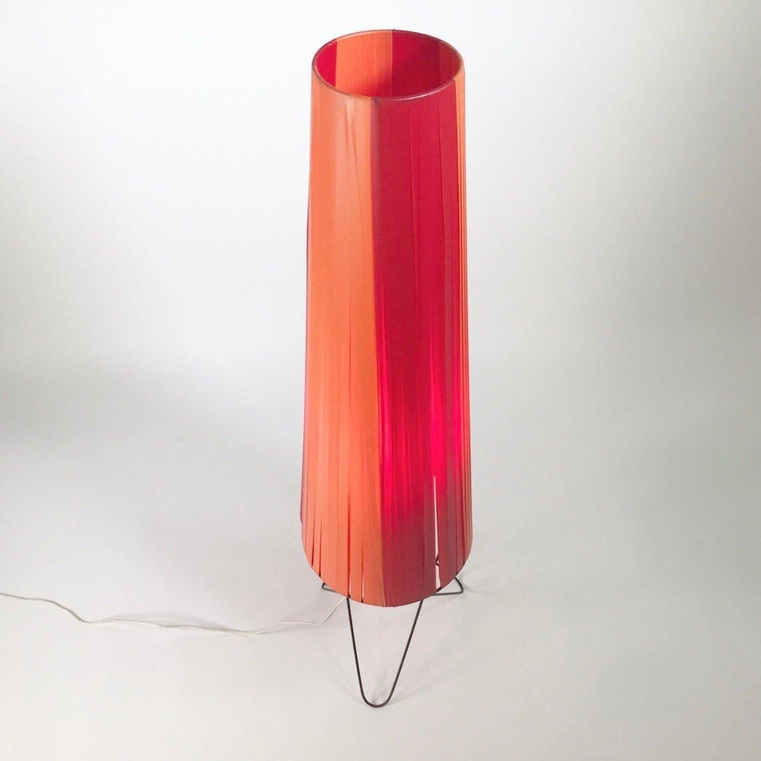 Beautiful eye-catching floor lamp by Nisse Strinning 1950s, Sweden. 

Black lacquered tube steel base with a shade that is made of red and orange plastic strings. The chimney shaped large shade has the typical 1950s look. 

When lit the