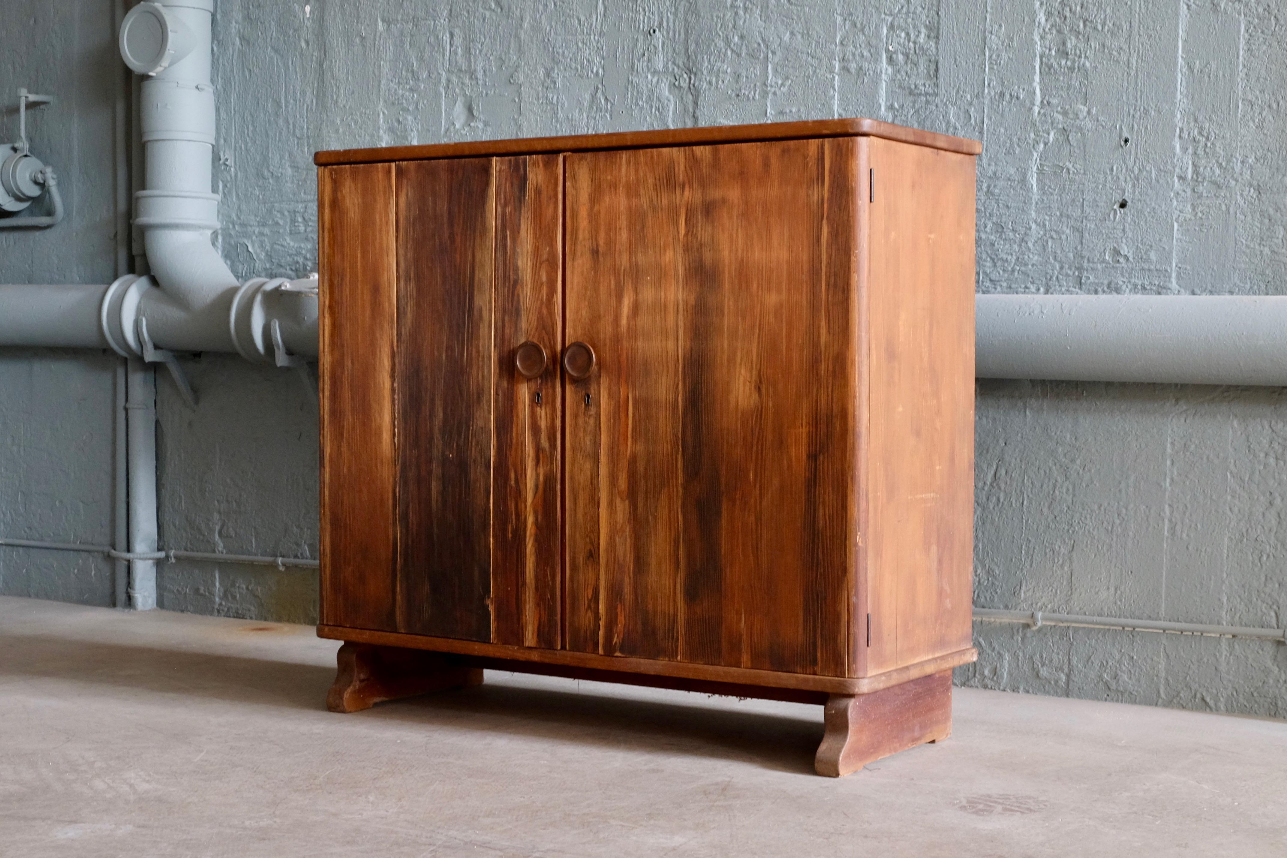 Rare Swedish dark stained pine cabinet with wonderful patina. Designer unknown. Produced in Sweden, late 1930s. Locker with key in working condition.