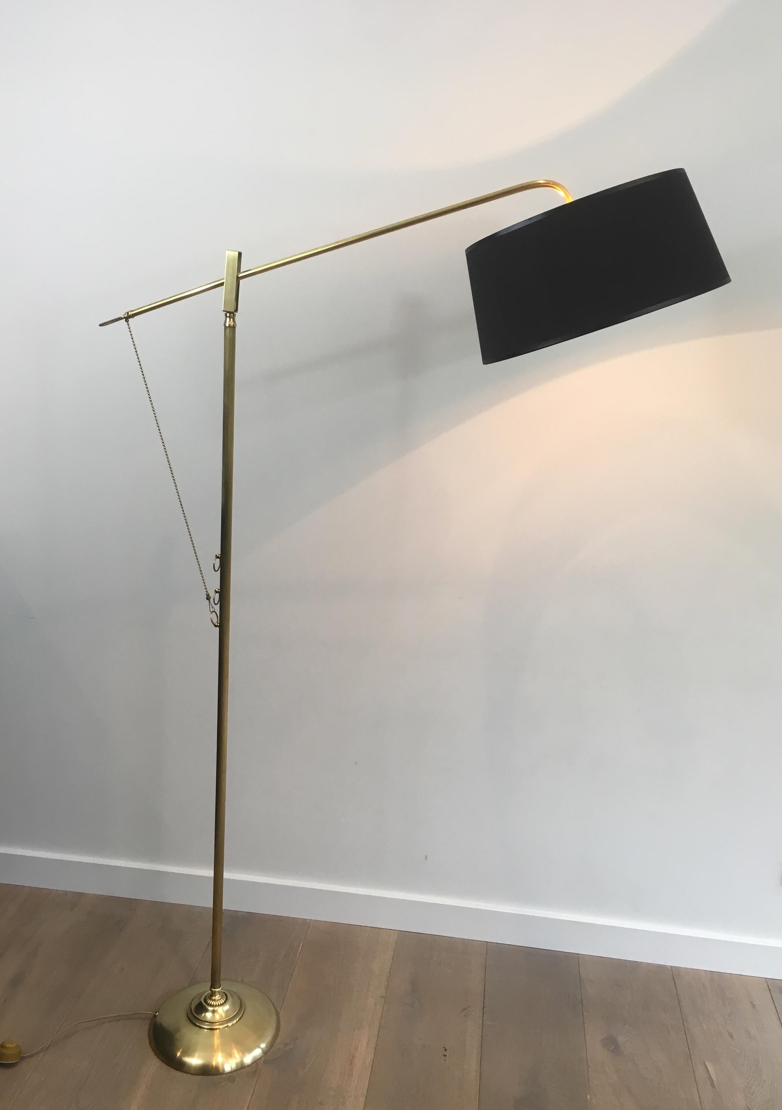 This rare swinging turning floor lamp is made of brass with a black shintz shade, gilt inside. This is a French work, circa 1940.