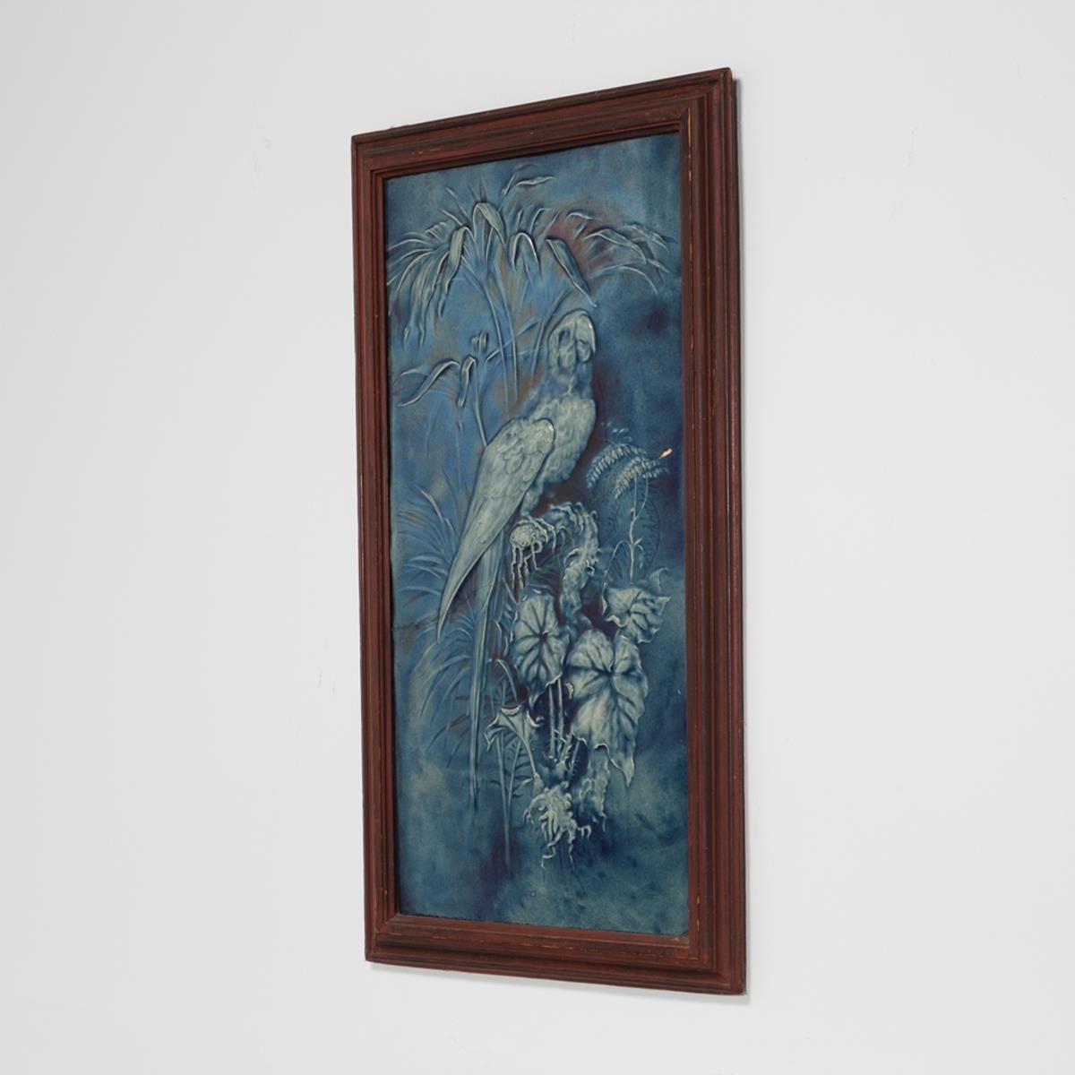 Framed rare Swiss blue and white ceramic relief of a parrot amongst foliage from Birmenstorf, CH circa 1860.
 