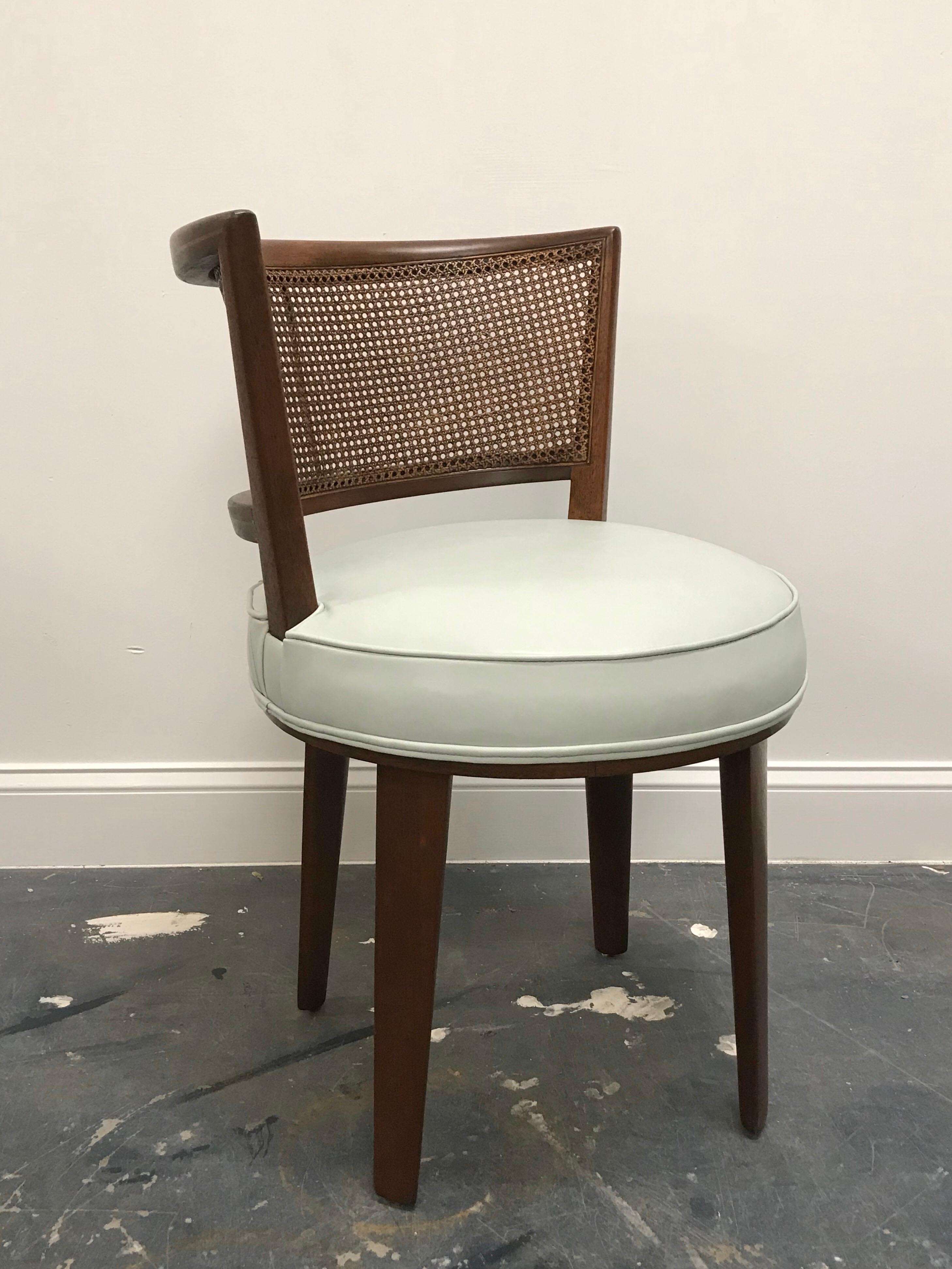 Rare and exceptional vanity or accent chair by Edward Wormley for Dunbar. Chair feature a mahogany frame, cane back, and leather seat. Leather is an off-white/ light blue, there is a very faint mark on the seat, which could be an inconsistency in