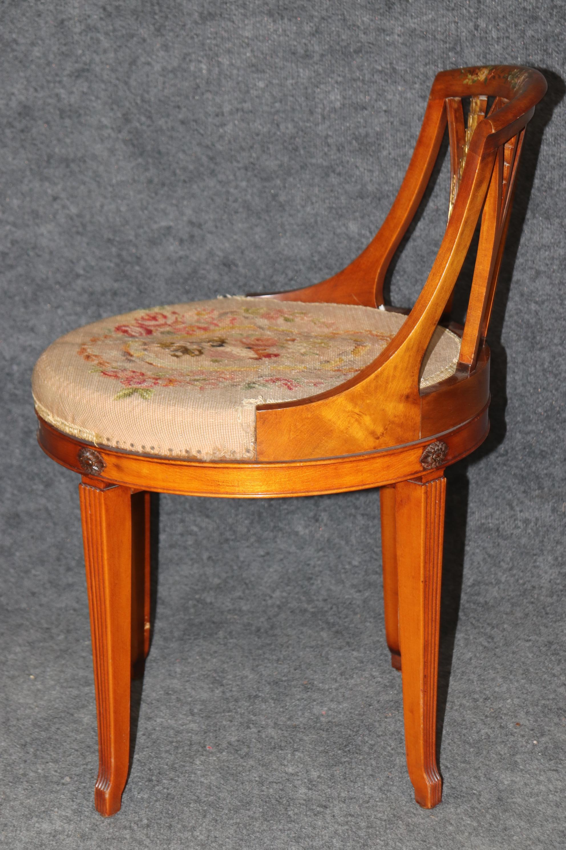 This gorgeous swiveling stool is paint decorated and fitted with petite-point needlepoint upholstery. The stool is decorated and painted with floral motif and is in very good antique condition. The stool swivels and is missing some minor fabric trim