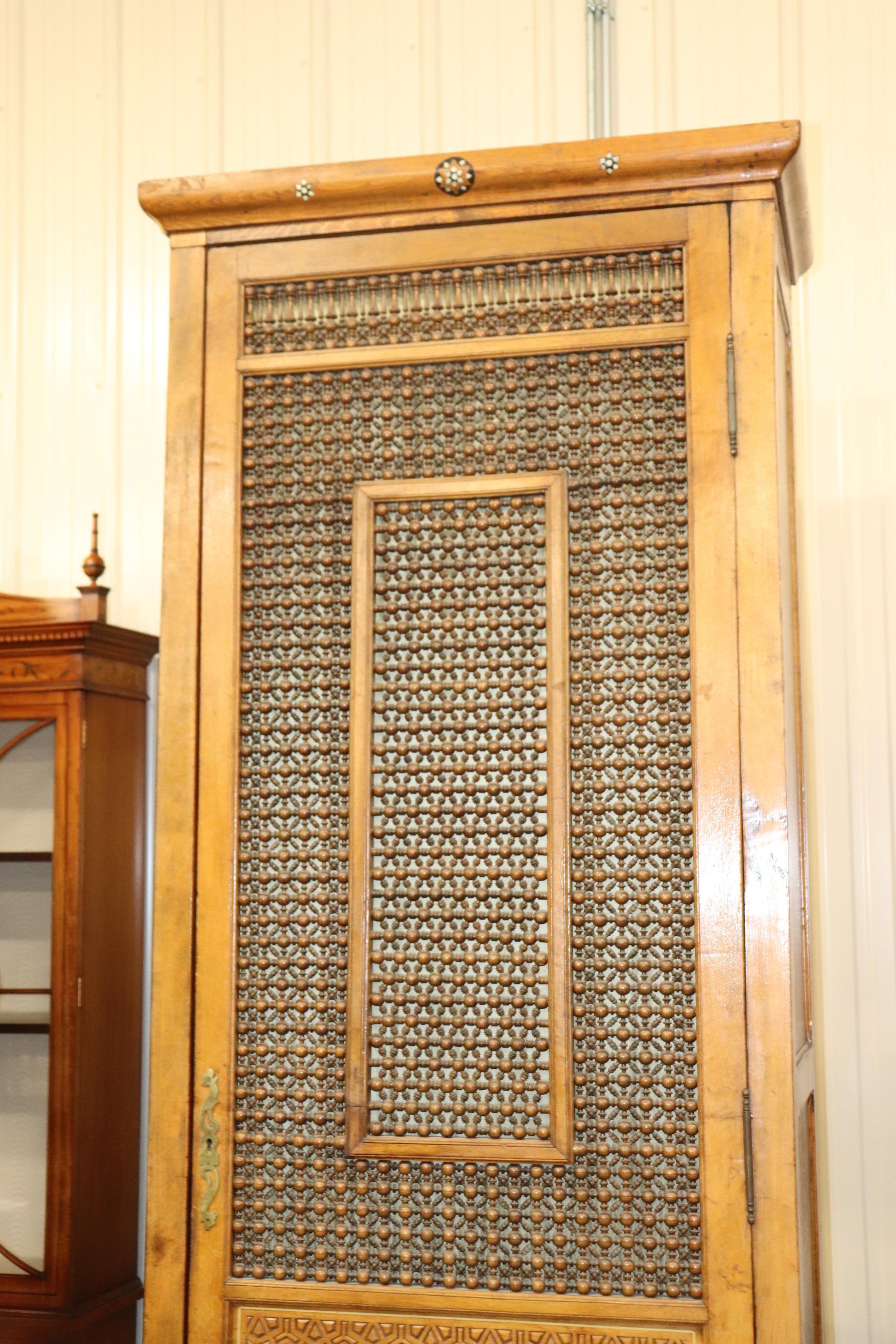 This is a fantasic and truly unique piece! This is either a Syrian or Morocan armoire made during the late 1890-1900s era and is in good condition with a newer back and newer fitted interior. The armoire measures 97 tall x 17 deep x 36 wide.