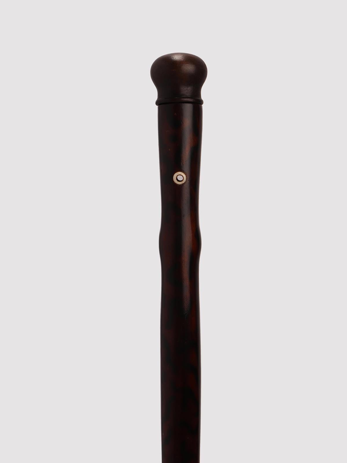 Very rare gadget-System walking stick: stick with the function of a music instrument, a flute. Painted fruitwood shaft, wooden handle. Inside the shaft is hollow, and holes and keys allow to play music once the handle is taken apart. Ferrule made