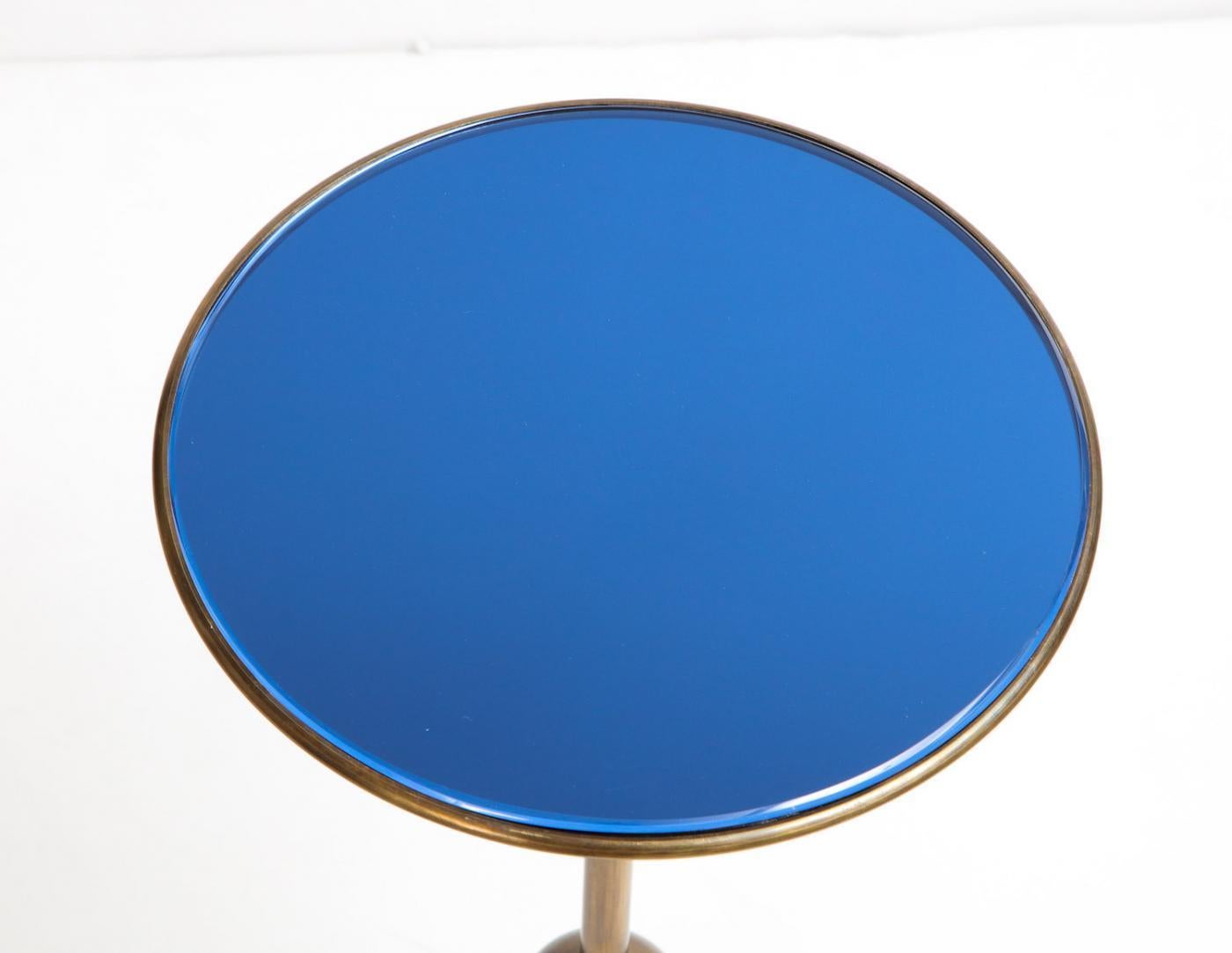 Nicely scaled, brass pedestal table with floating dented orb and inset sapphire-blue mirrored top. A rare and early example of this model. Very good condition. Mirrored top may have been replaced. Wear and oxidation to metal.
Published: Osvaldo