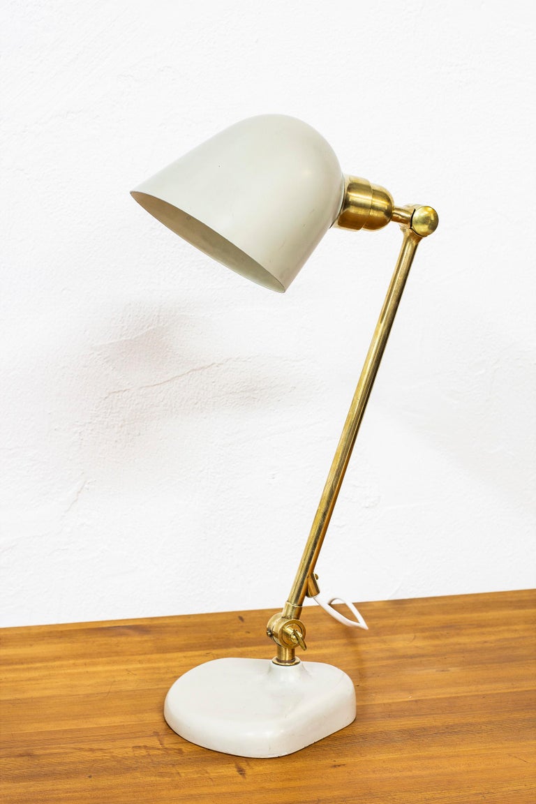 Rare table lamp designed by Bertil Brisborg and produced by Nordiska Kompaniet during the 1940s. Cast iron base with brass and aluminum shade. Adjustable in angle. Very good vintage condition with some age related signs of wear and use.