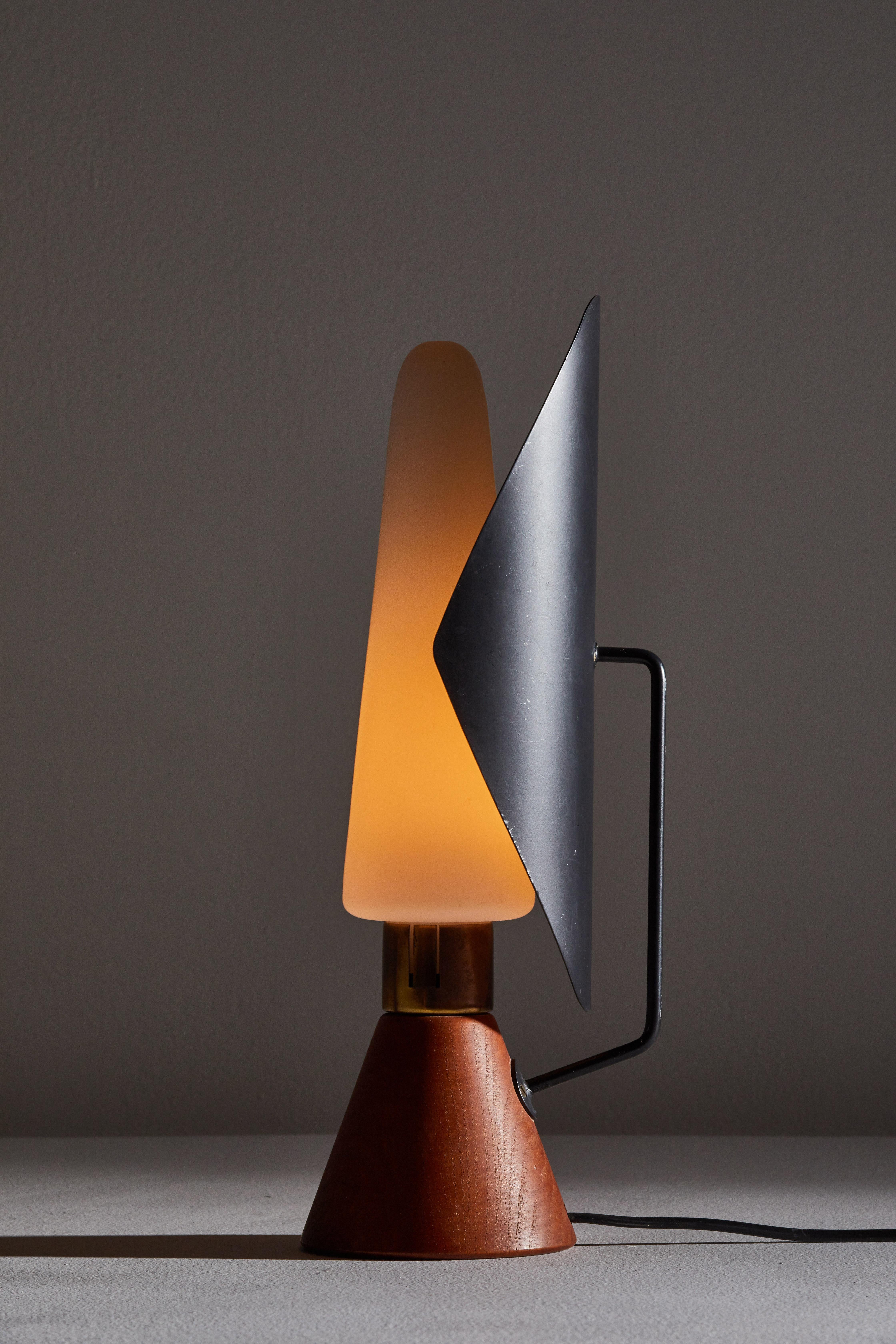 Rare table lamp by Svend Aage Holm Sørensen for ASEA . Designed and manufactured in Sweden, circa 1950s. Teak base, enameled metal reflector, brass fittings, and brushed satin glass diffuser. Original cord. Takes one E27 European candelabra 75w