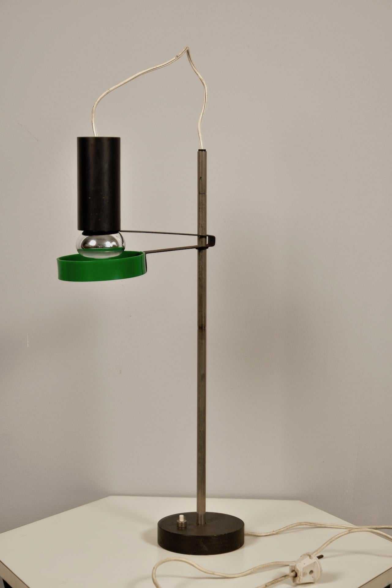 Model 565 a direct light table lamp designed in 1956, has distinctive steel spring that holds the spotlight reflector.