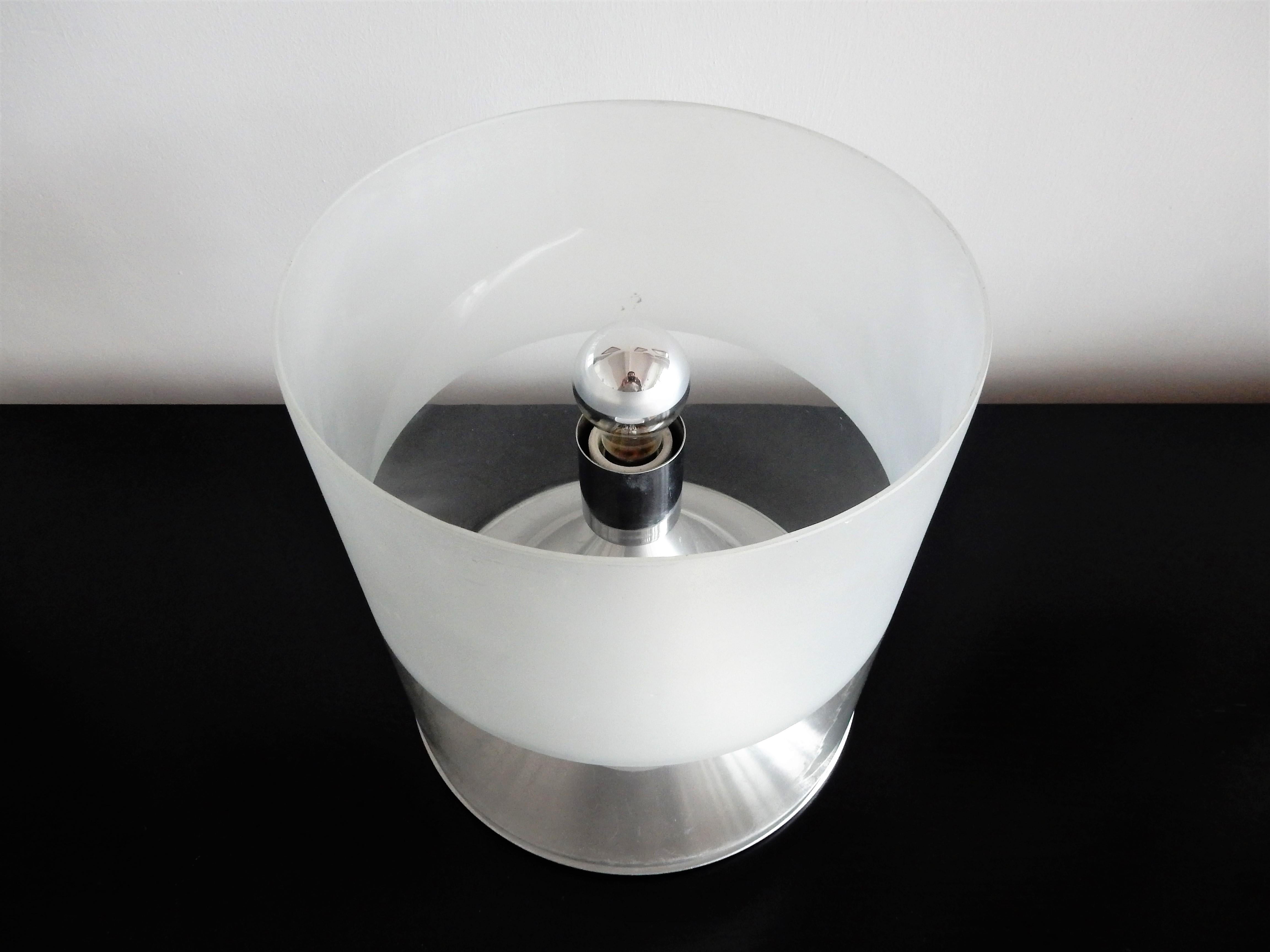Rare table lamp by RAAK Amsterdam. Aluminum base with a glass tube, half clear and half opaline. A very special design where the bulb is hidden in a foggy mist on top of its socket on a clear mountain. Both lamps are in very good condition with