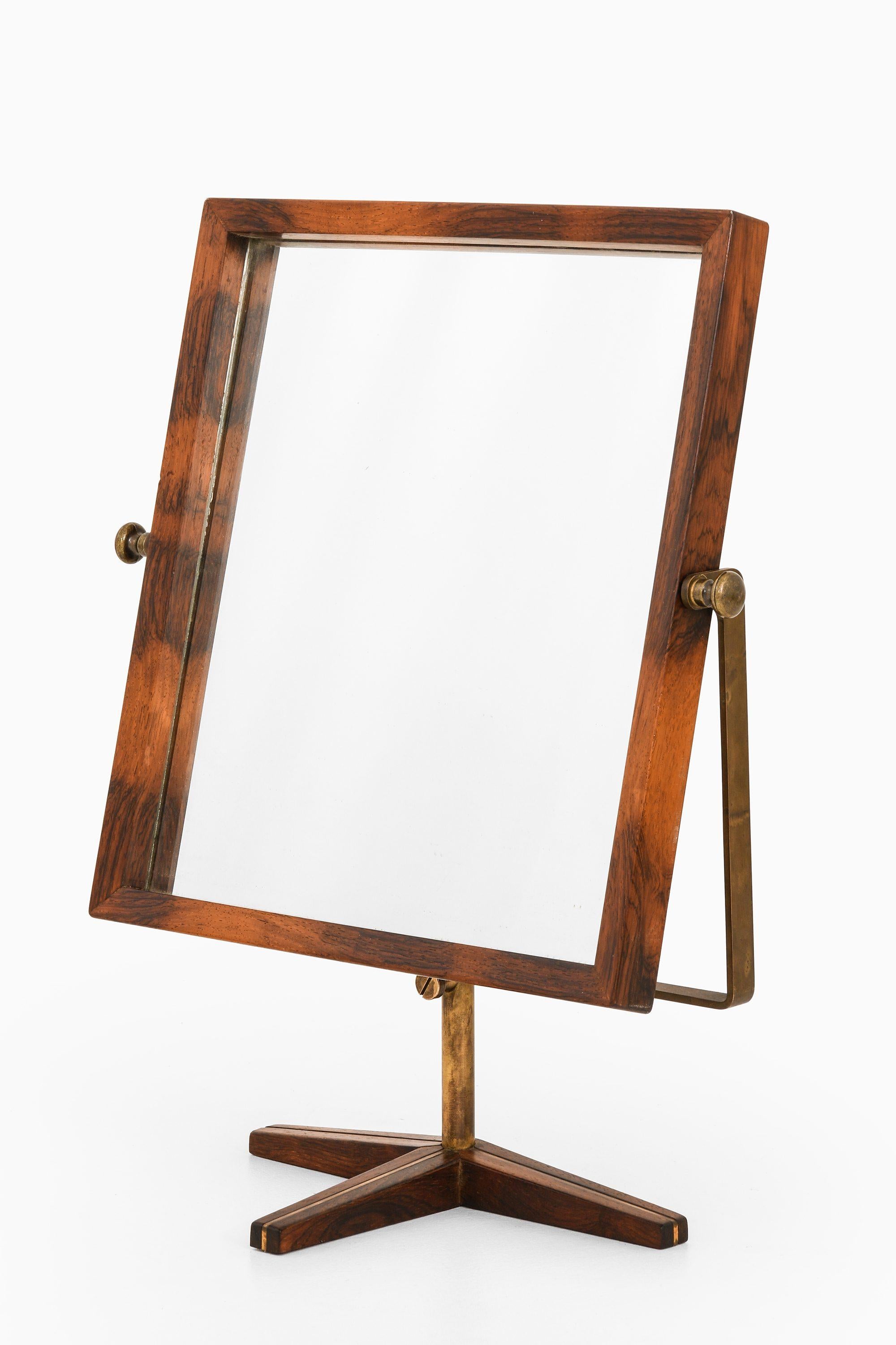 Rare Table Mirror in Rosewood and Brass, 1950's

Additional Information:
Material: Rosewood, brass
Style: Mid century, Scandinavian
Probably produced in Denmark
Dimensions (W x D x H): 48.5 x 18.5 x 59 cm