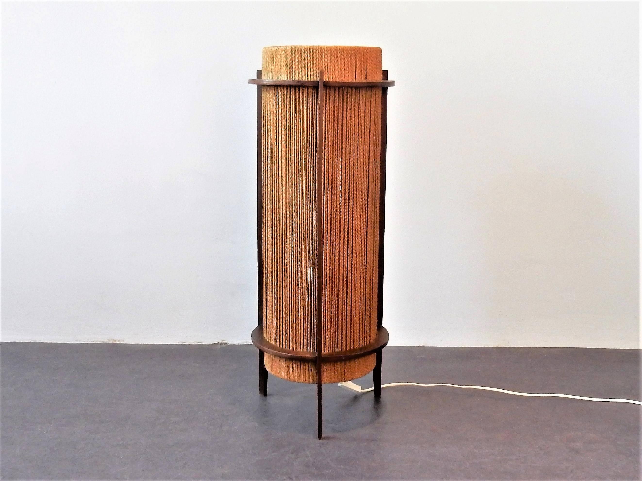 This rare teak and hemp string floor lamp is made by Ib Fabiansen for Fog & Mørup. It was made in Denmark in the 1950's. This lamp is in a good condition and gives a nice warm light. The (ply)wooden construction has had some restoration done and