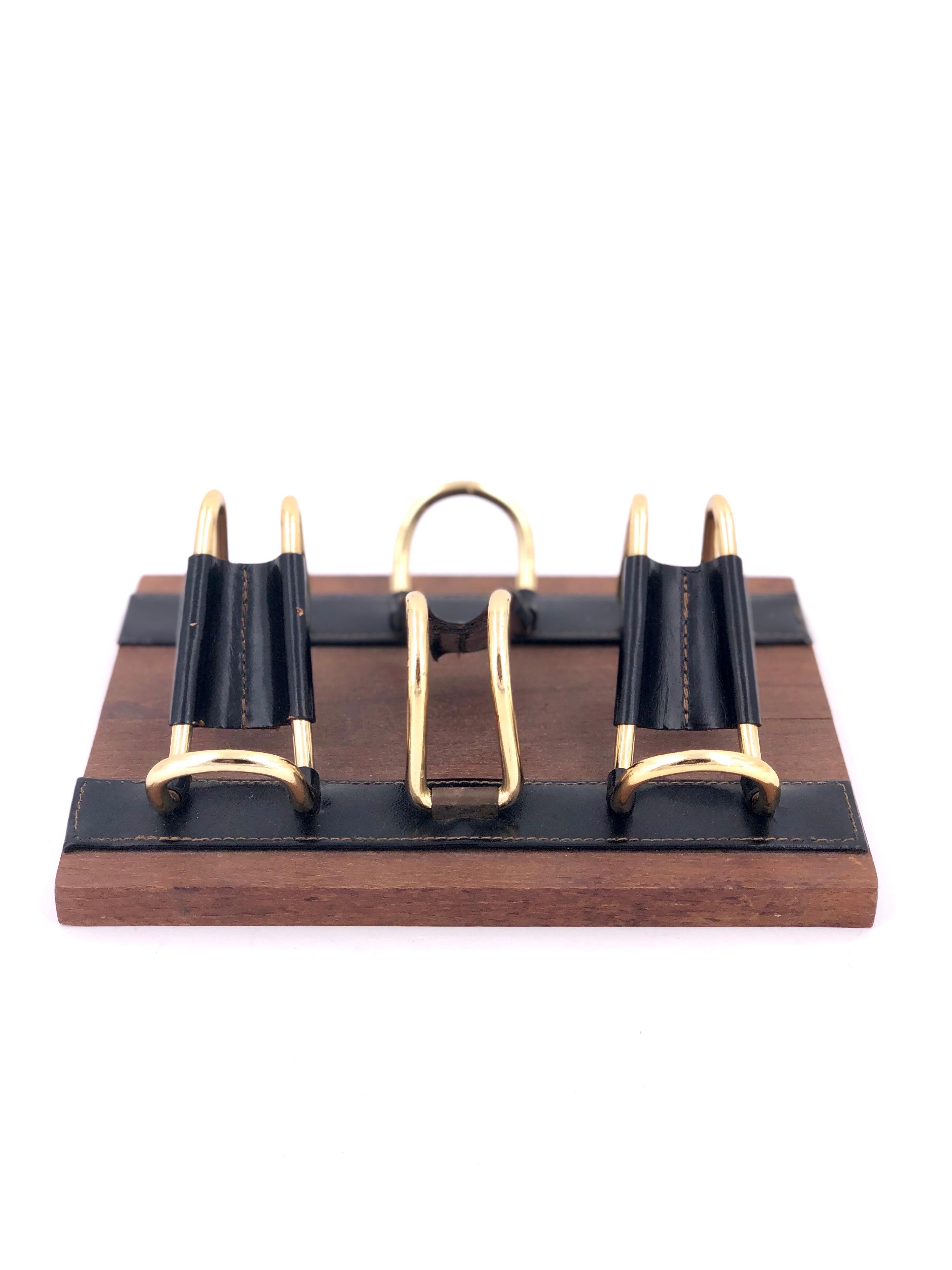 Great elegant Mid-Century Modern solid teak, with brass and leather pipe rest holder. In the style of Jacques Adnet.