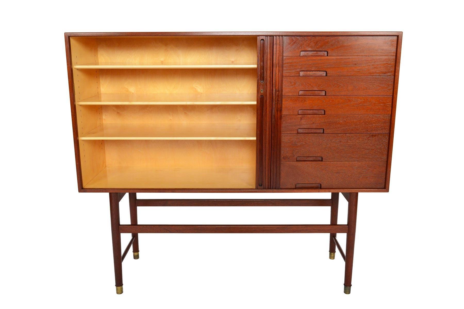 This rare and breathtaking tall teak credenza was designed by Ib Kofod Larsen for Christiansen & Larsen in the 1950s. This early example of Kofod Larsen's work displays meticulous and detailed craftsmanship, and is a piece rarely offered for sale. A