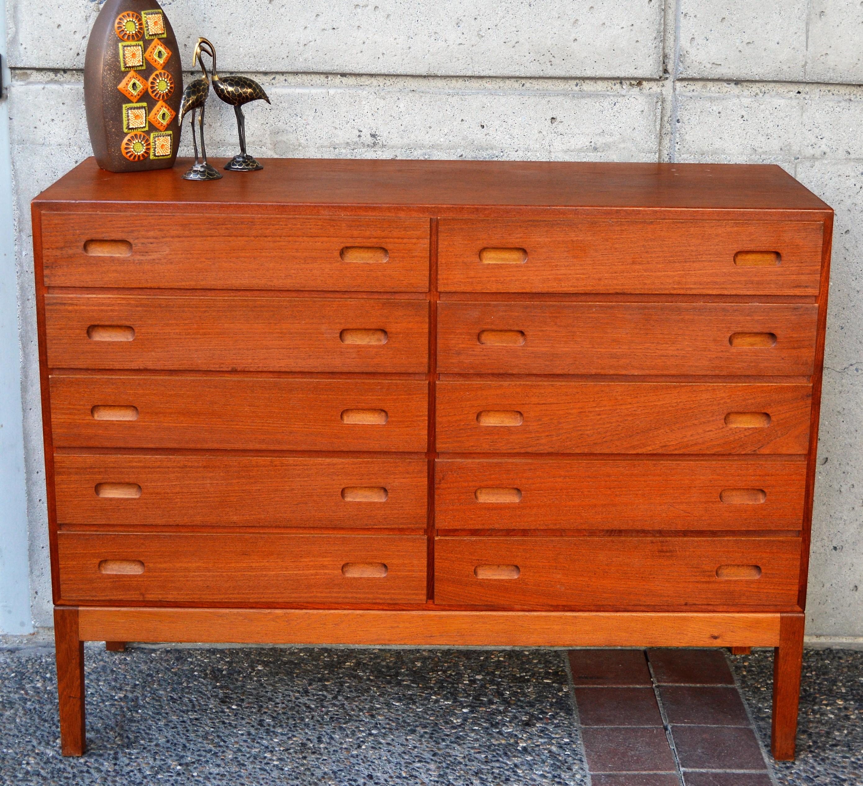 This rare and amazing quality Danish Modern teak taller 10-drawer dresser was designed by Borge Mogensen for FDB Mobler in the 1960s. The drawers all have solid wood drawer fronts with unusual cut-away ovoid drawer pulls, and oak frame construction
